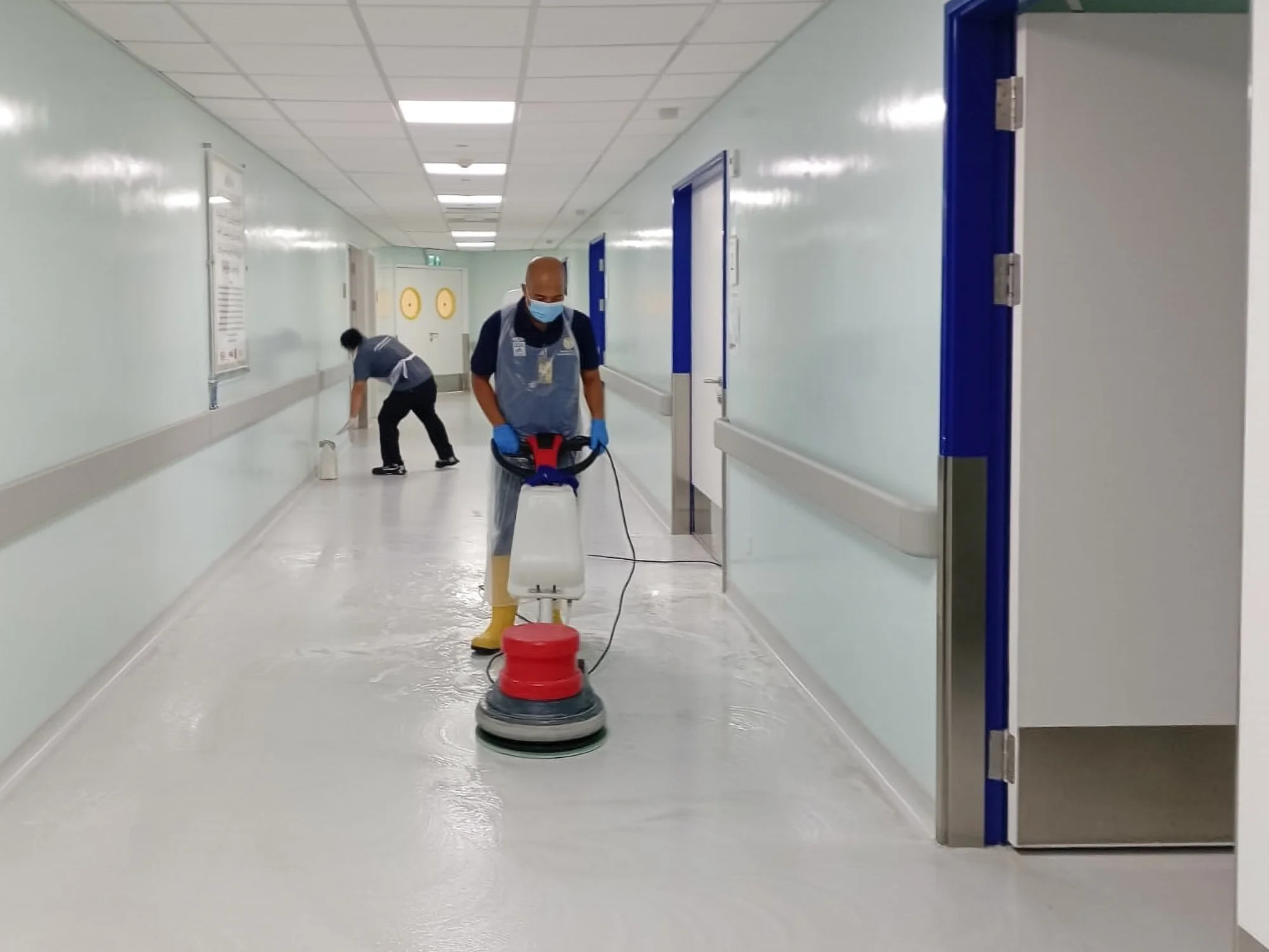 Professional floor scrubbing taking place in a hallway of a hospital in Brunei.