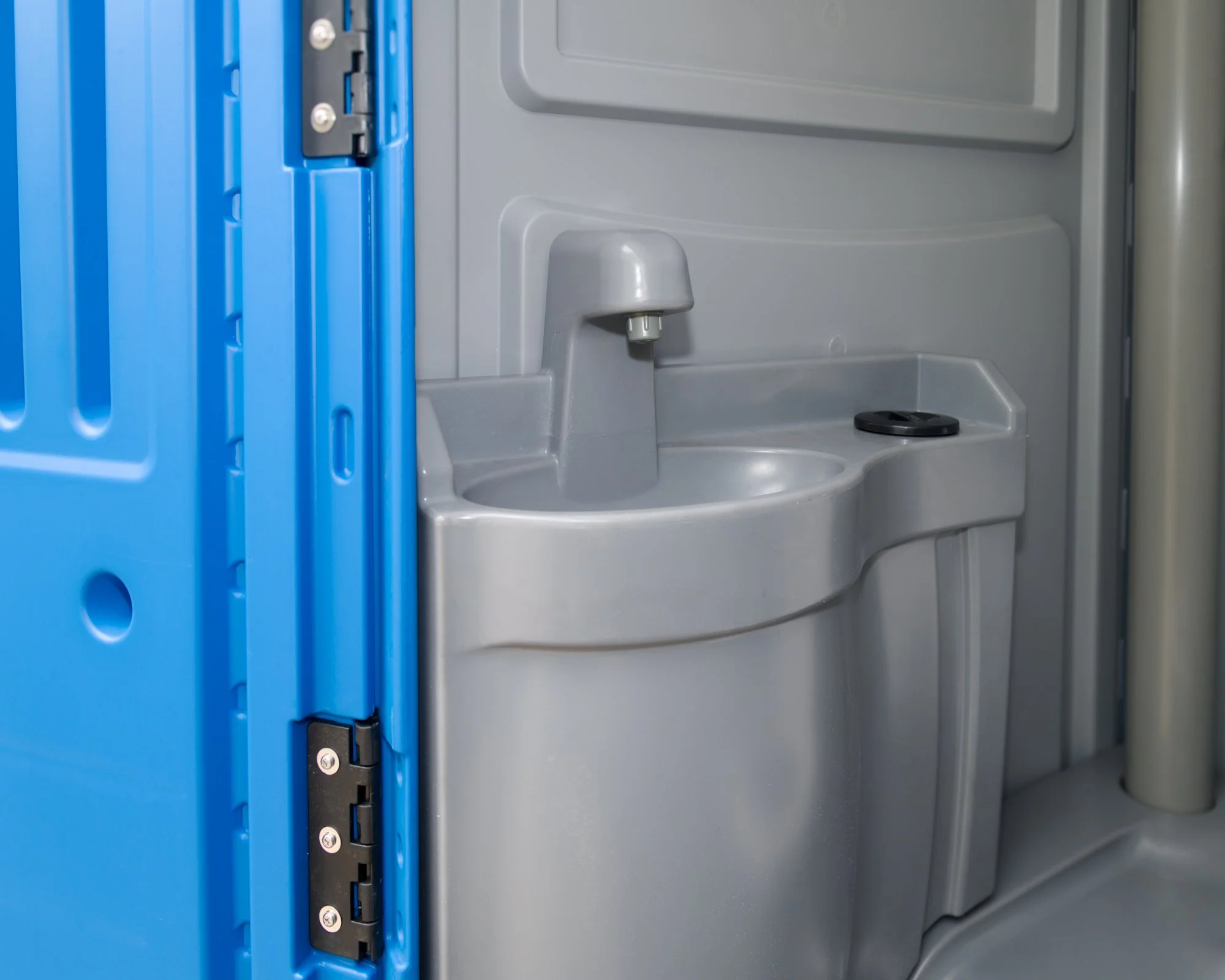 An interior look depicting sink and tap of the full-service portable toilet rental in Brunei.