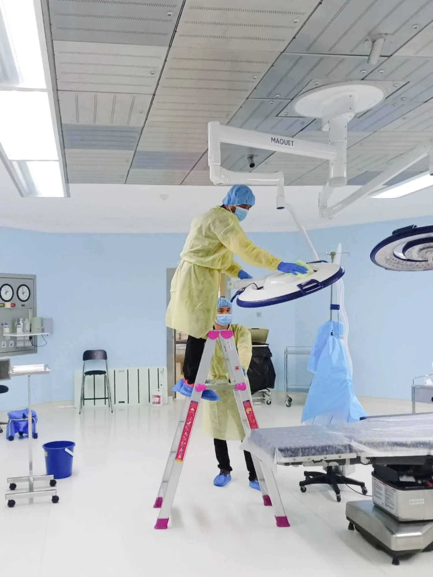 Professional cleaners sanitising a hospital operating room in Brunei.