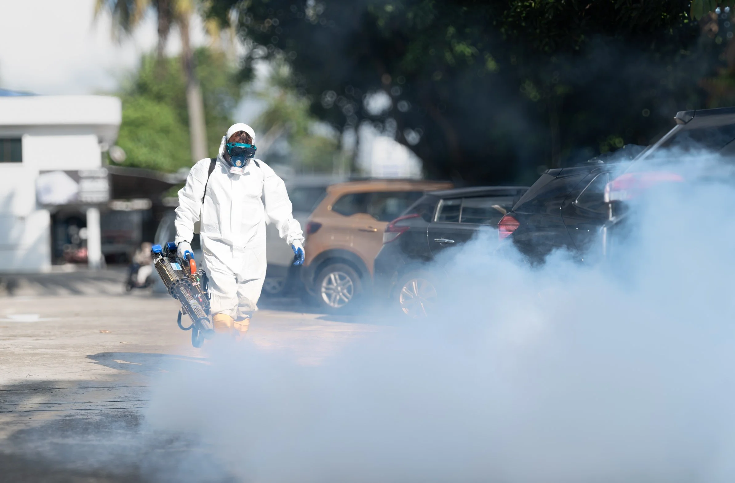 Professional mosquito fogging service carried out outdoors of a commercial complex in Brunei.
