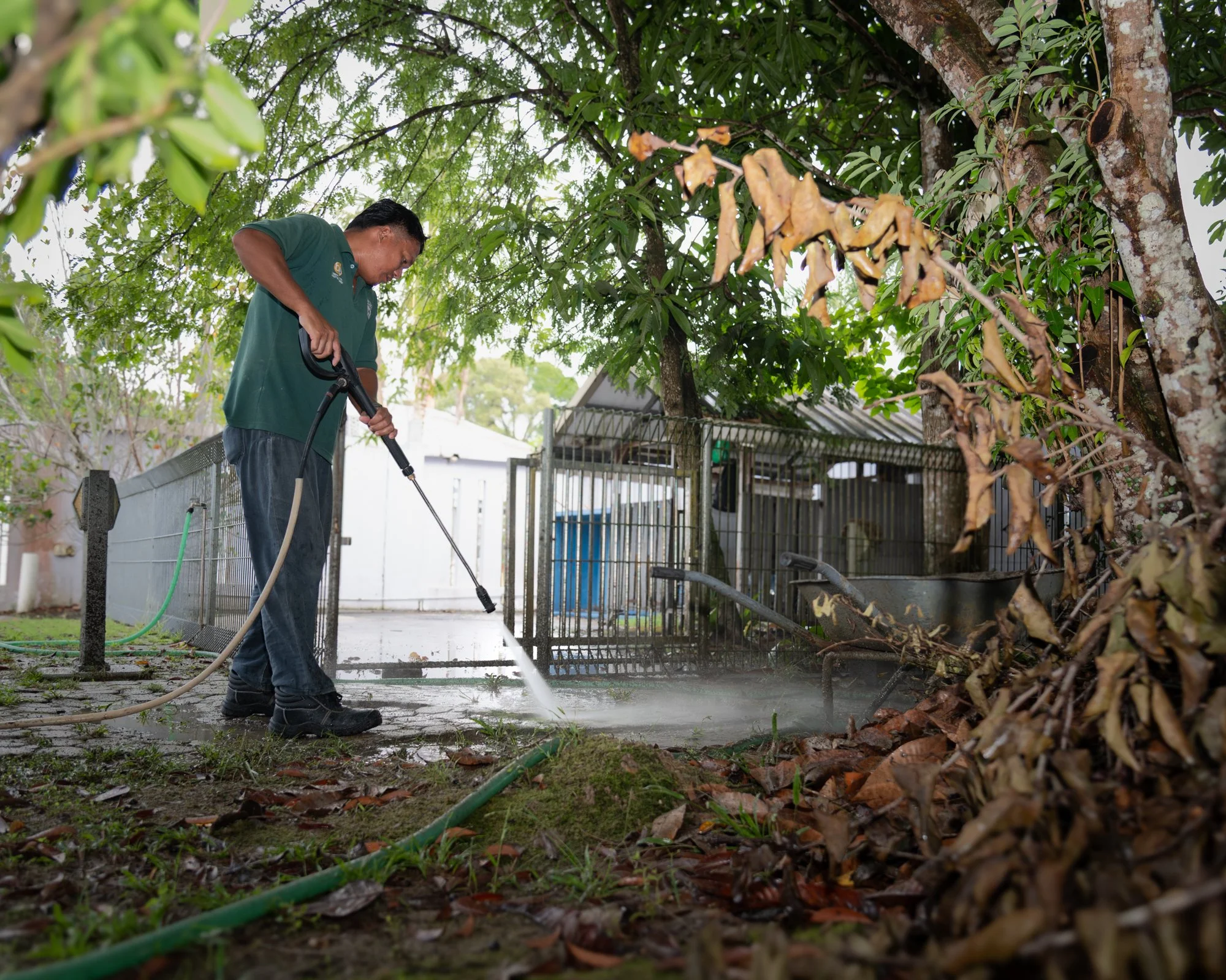 Professional pressure washing services for an outdoor concrete surface at a residential property in Brunei.