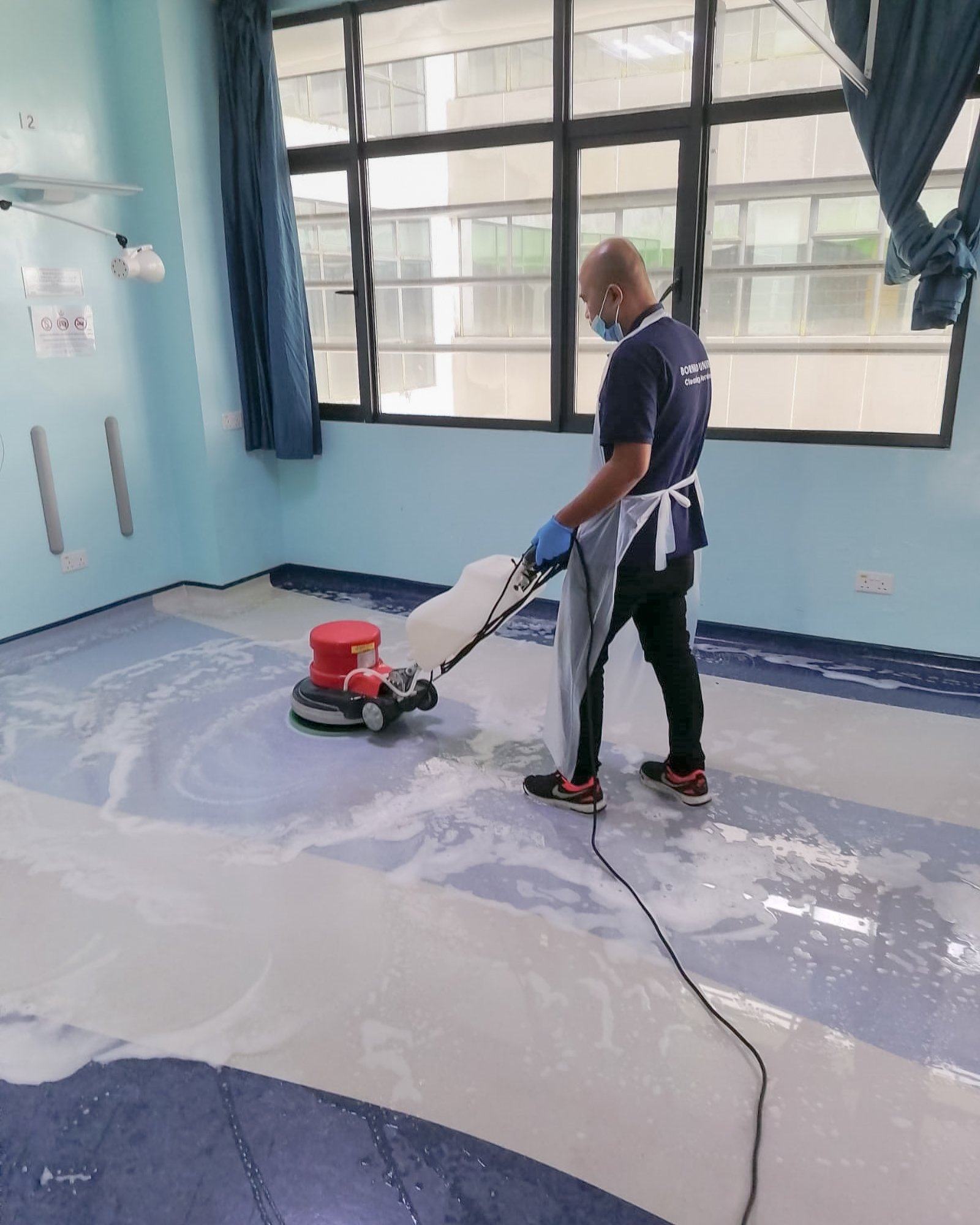 Professional floor scrubbing taking place in a  a hospital ward in Brunei.