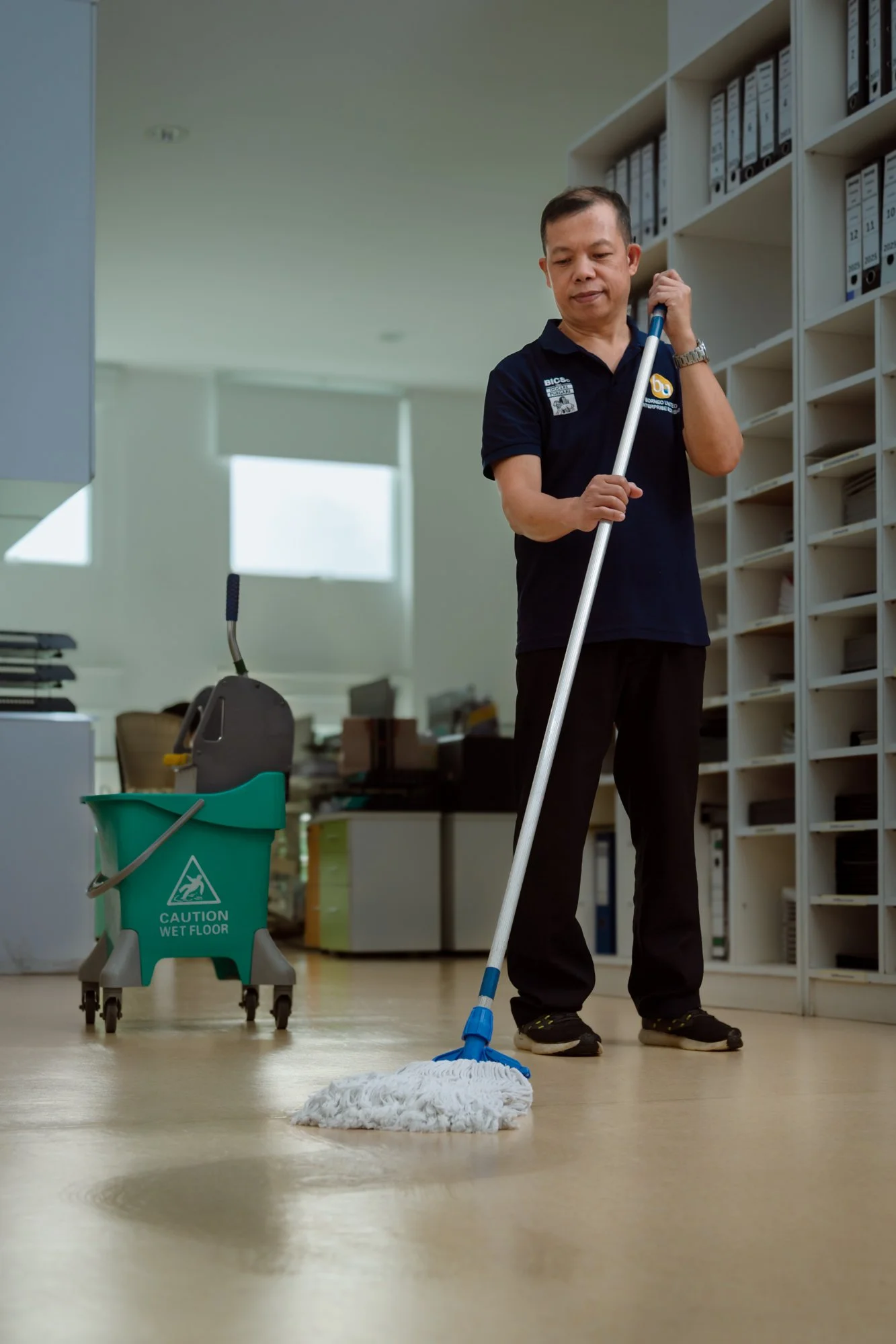 Professional janitorial cleaning and mopping taking place in an office in Brunei