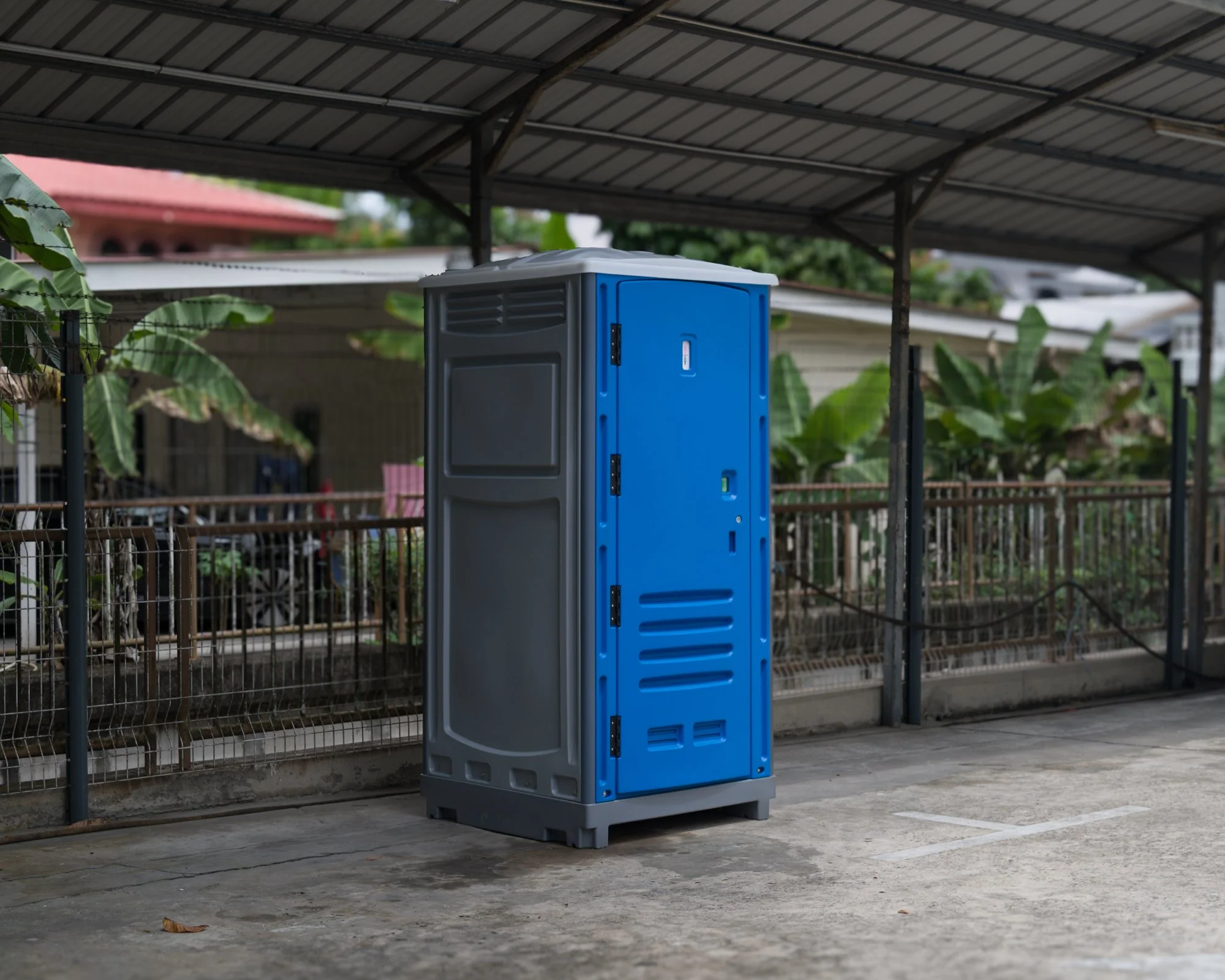 A full-service portable toilet rental situated outside an office in Brunei.