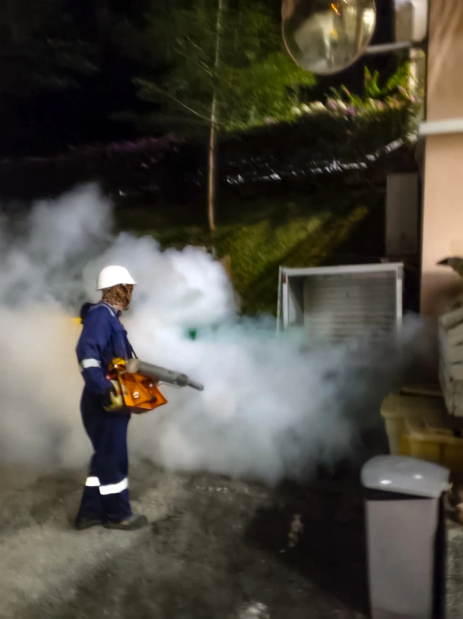 Professional mosquito fogging service carried out outdoors of a building in Brunei.