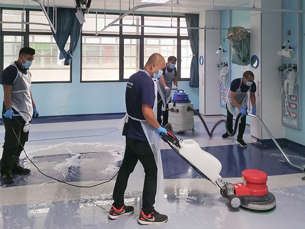 Professional hospital floor scrubbing and buffing service using a commercial floor scrubber machine in Brunei.