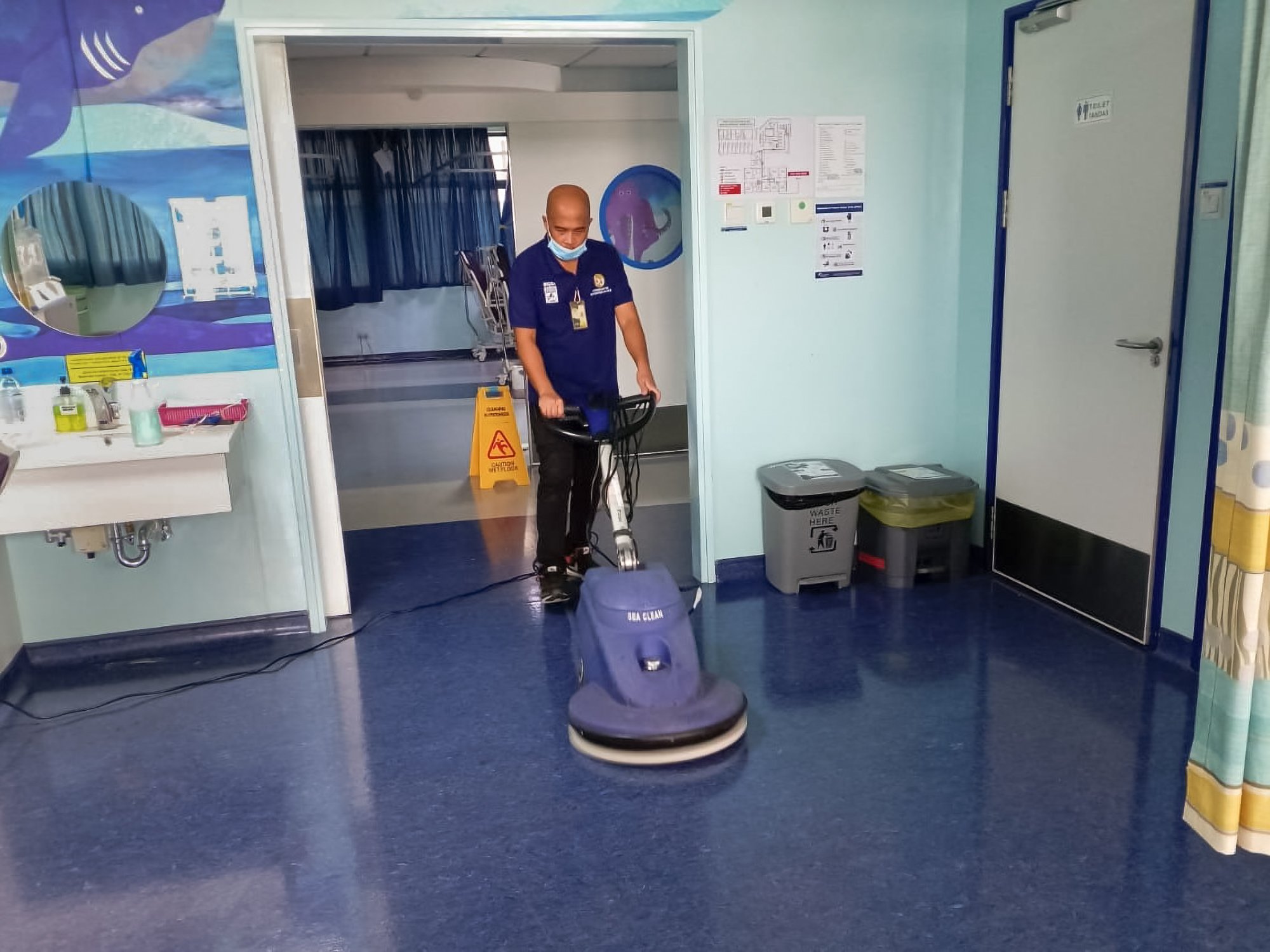 Professional floor polishing taking place in a  a hospital ward in Brunei.