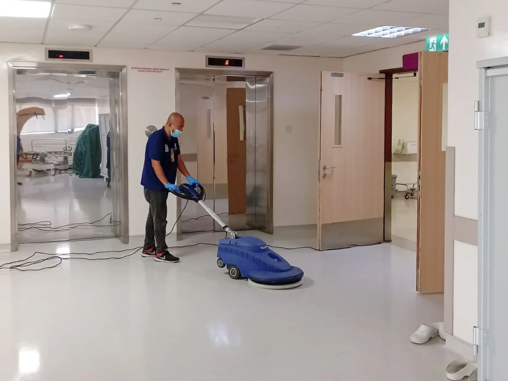 Professional floor polishing taking place in a corridor of a building in Brunei.