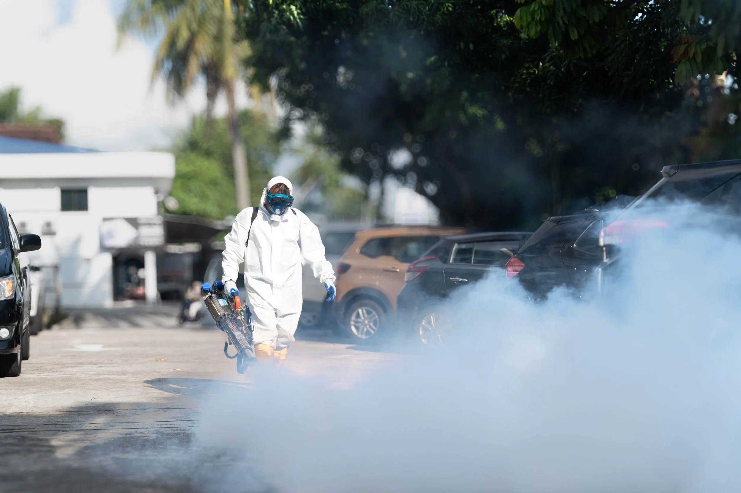 Professional mosquito fogging service carried out outdoors of a commercial complex in Brunei.