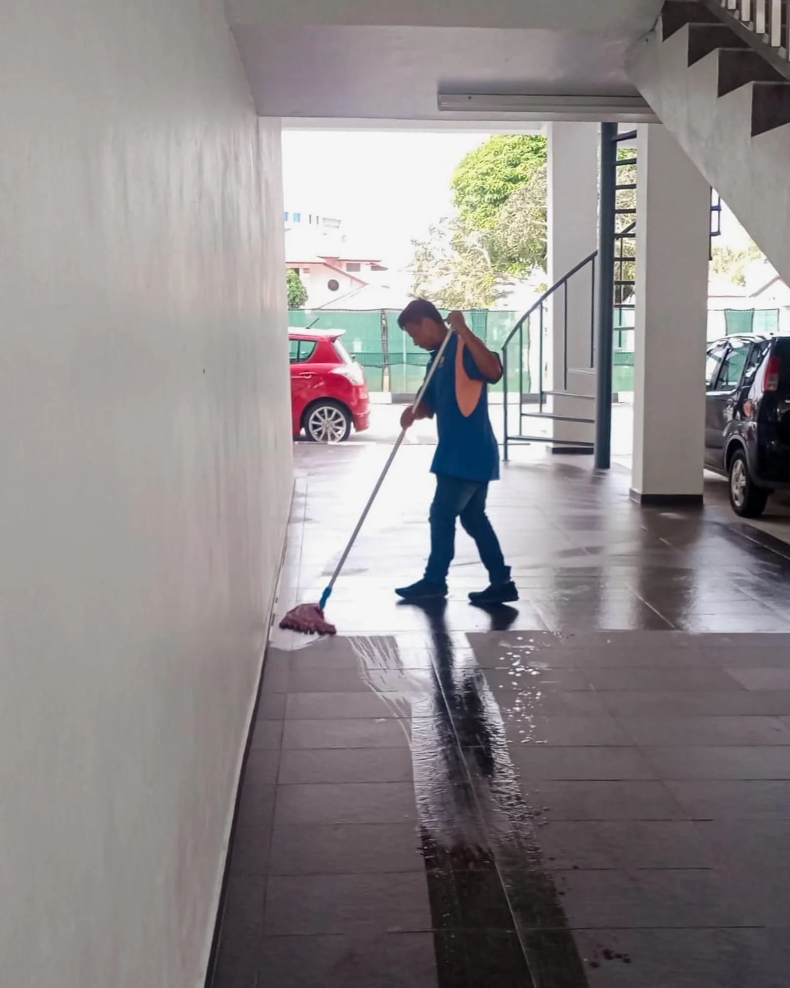 Floor sweeping taking place outside at a commercial complex in Brunei.