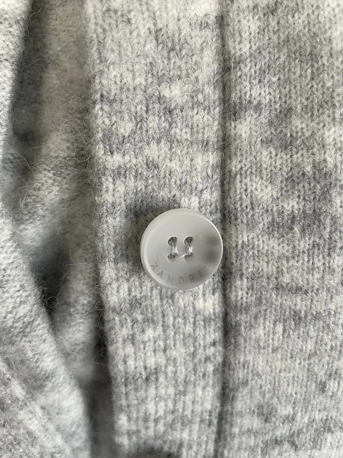 Xandres branded button close-up detail