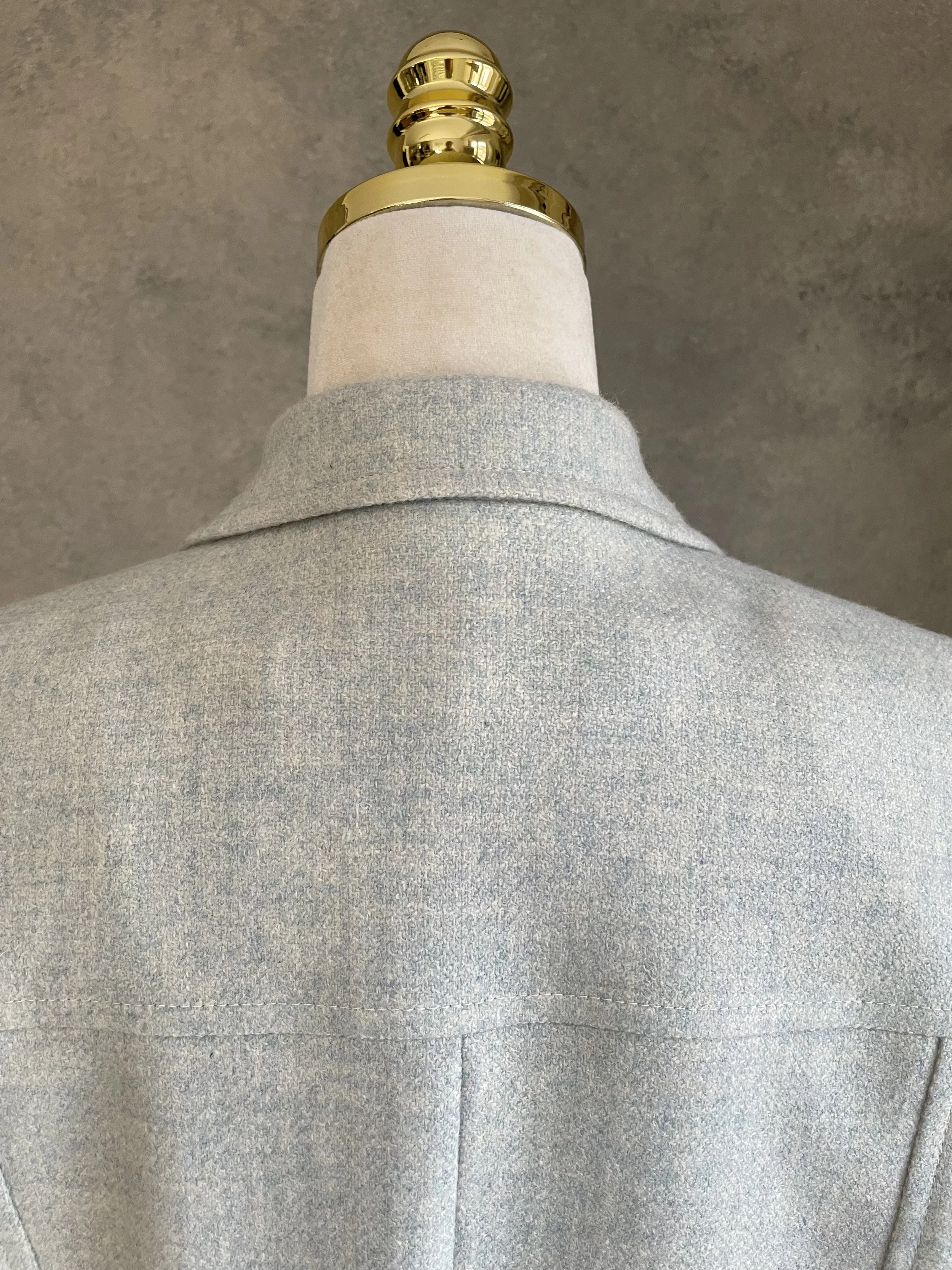 Close-up of the blazer collar, highlighting the fine texture of the wool fabric.