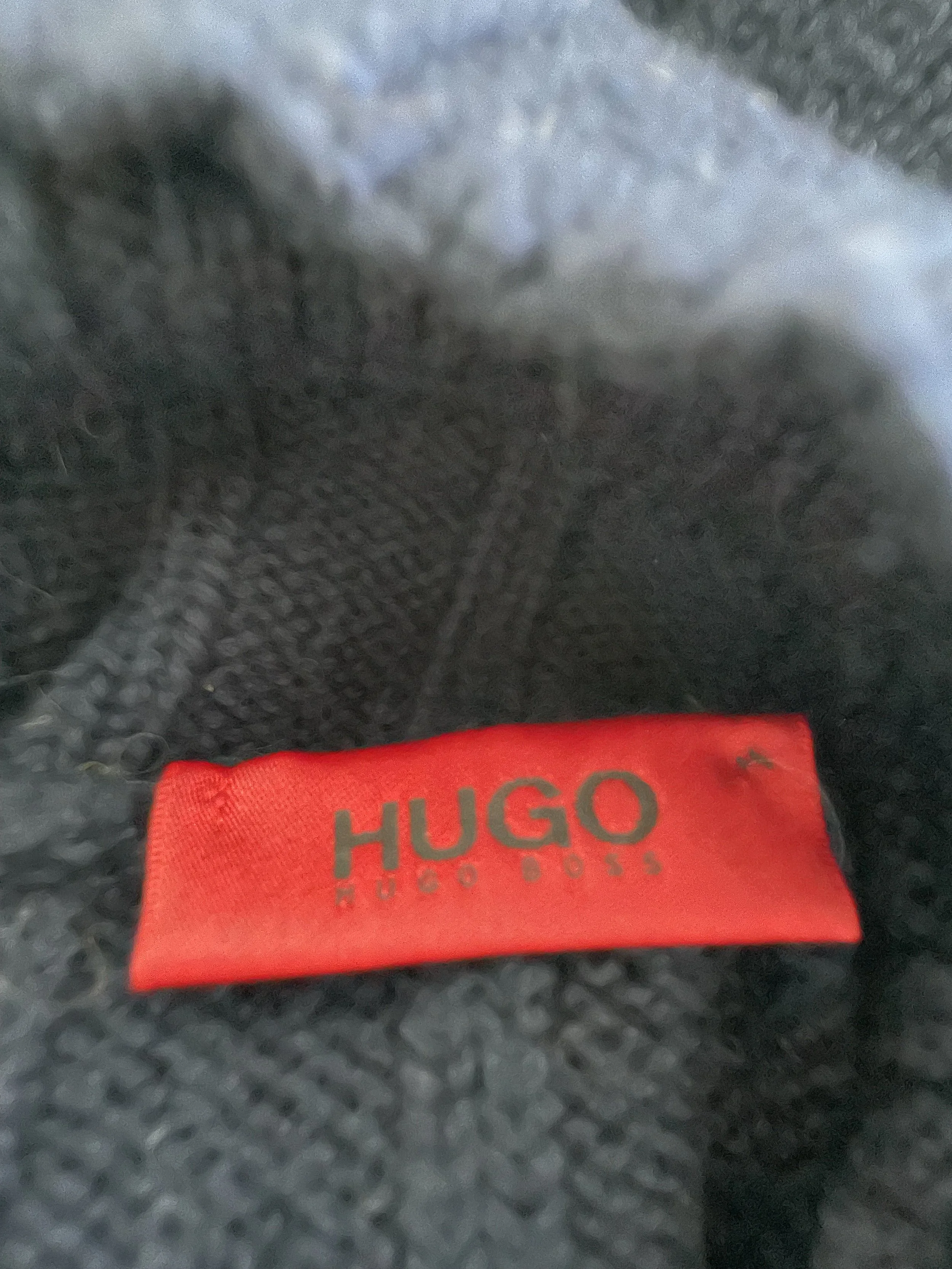 View of the Hugo Boss brand label and interior neck construction, confirming authenticity