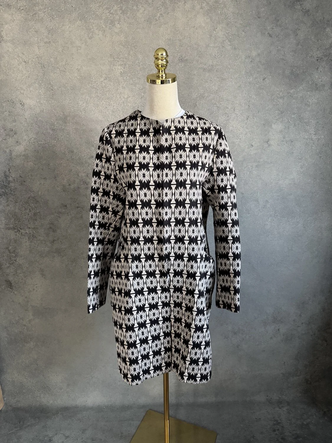 Angled view of Hoss Intropia patterned coat on mannequin showing side pocket placement