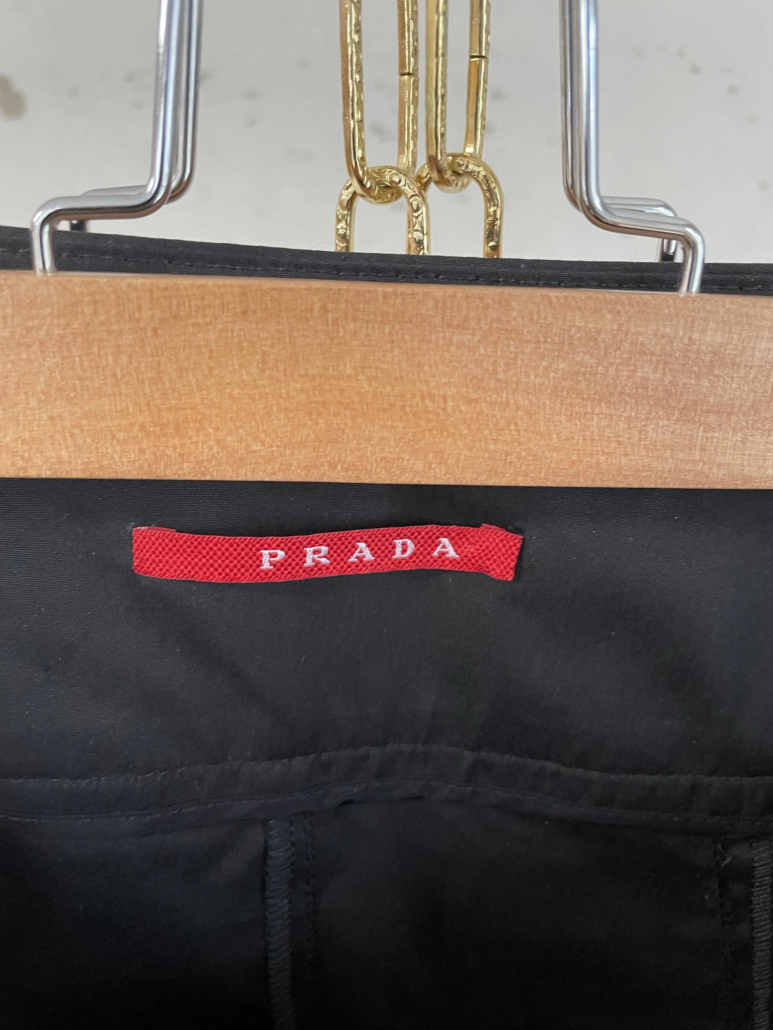 Detail view of the Prada brand tag and interior construction, confirming luxury authenticity.