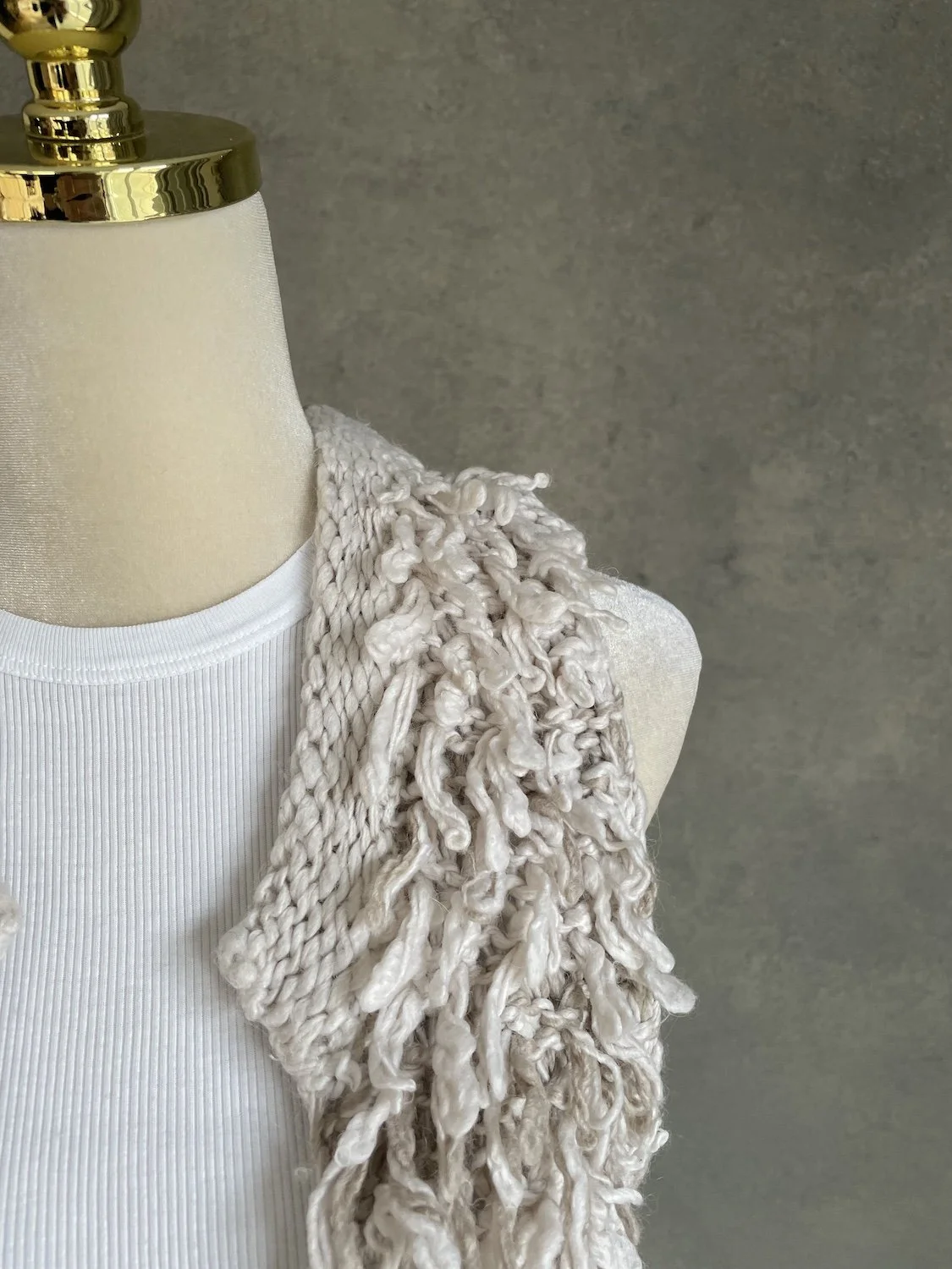 Close-up of the cascading shaggy fringe and shoulder construction