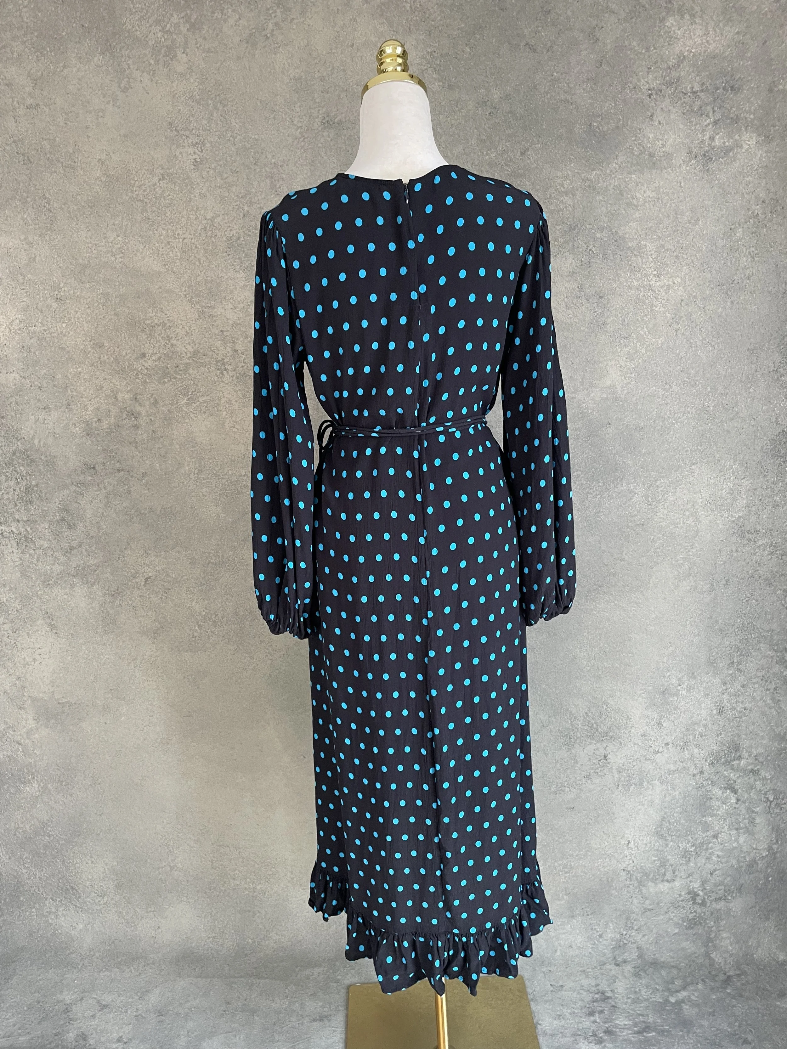 Full-length back view of the Essentiel Antwerp dress, showing the ruffled hem and length difference.