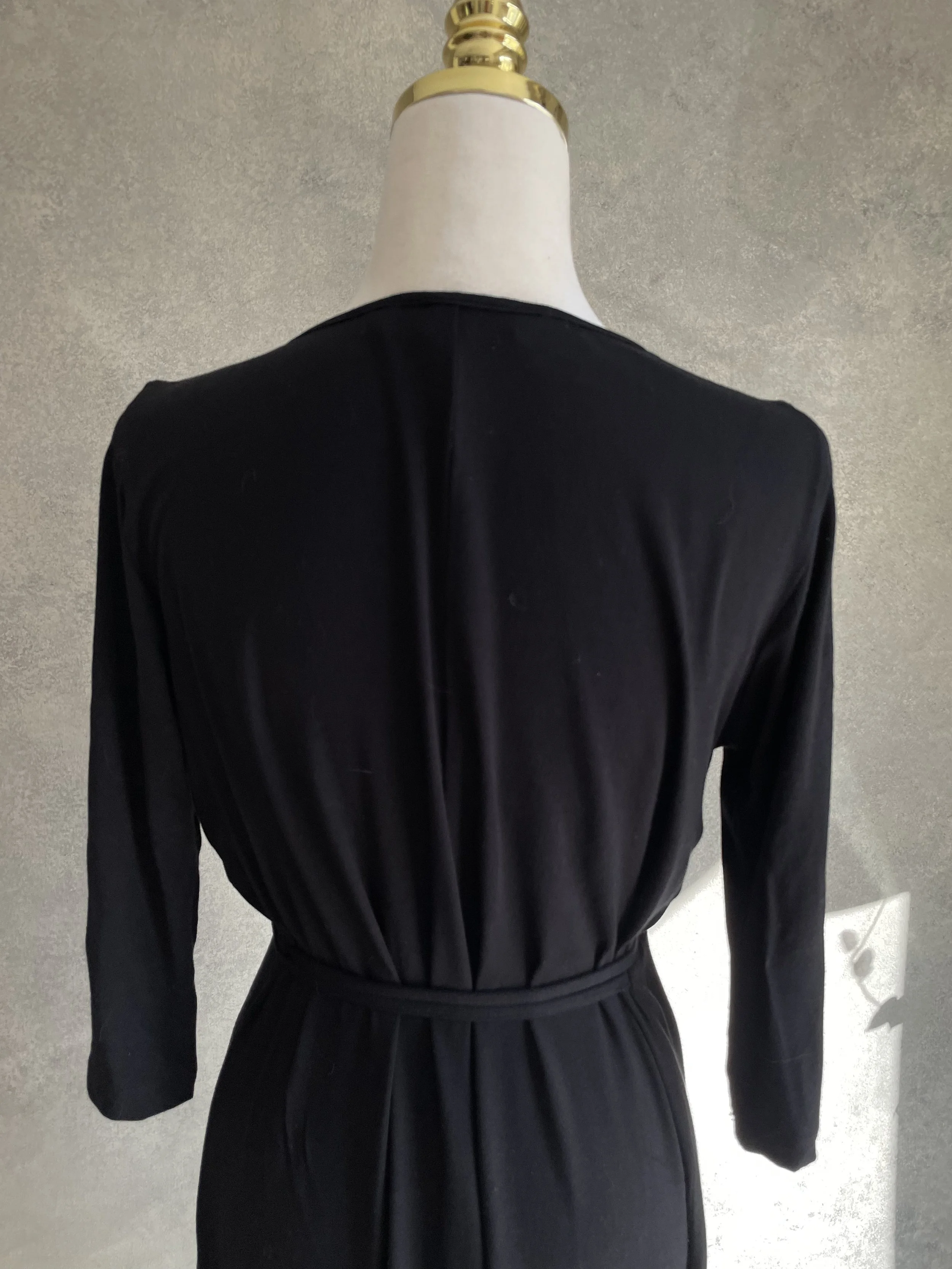 Close-up back view of the Scapa jersey dress, focusing on the fabric drape and construction.