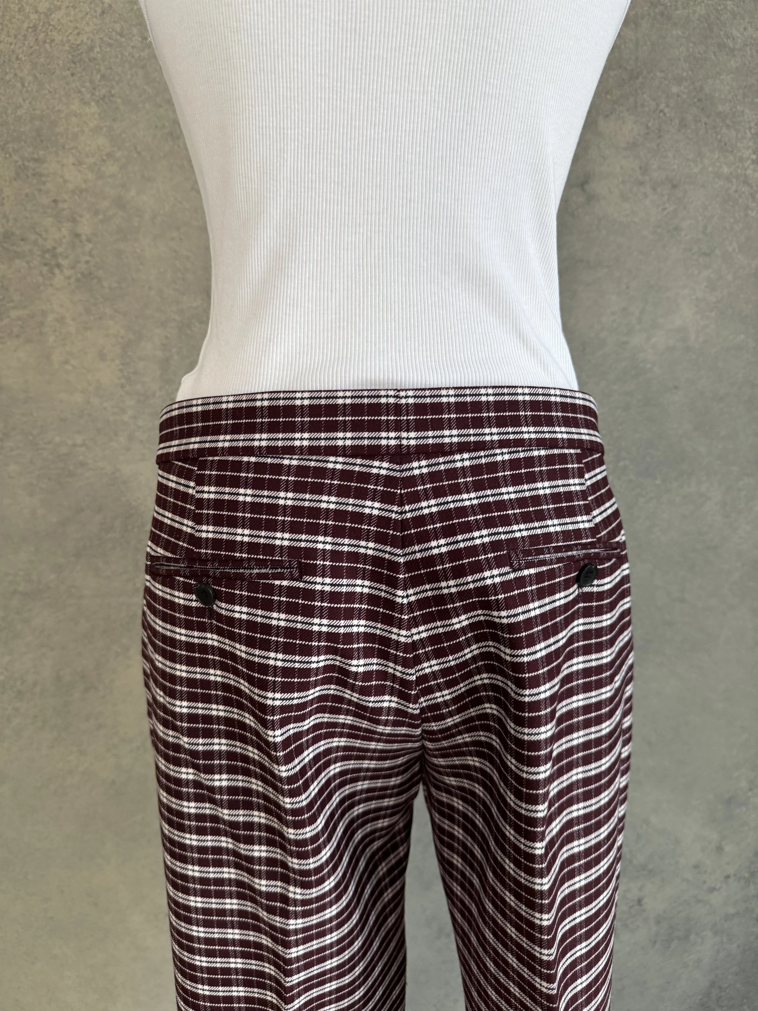 Close-up view of the back waistband and buttoned welt pockets on the JOSEPH trousers.