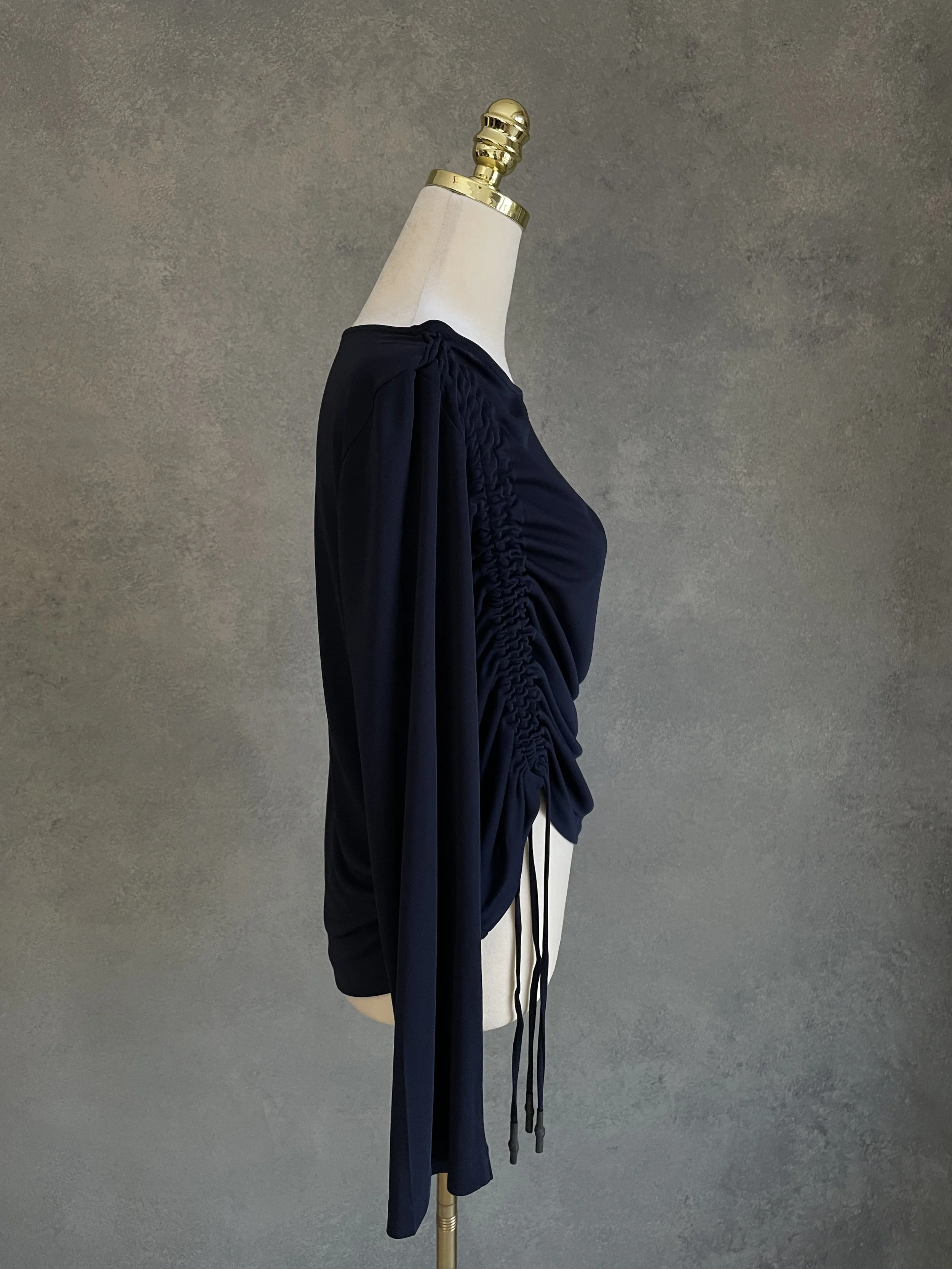 Side profile view of the navy blue BLANCHE top, highlighting the gathered drape and tie construction.