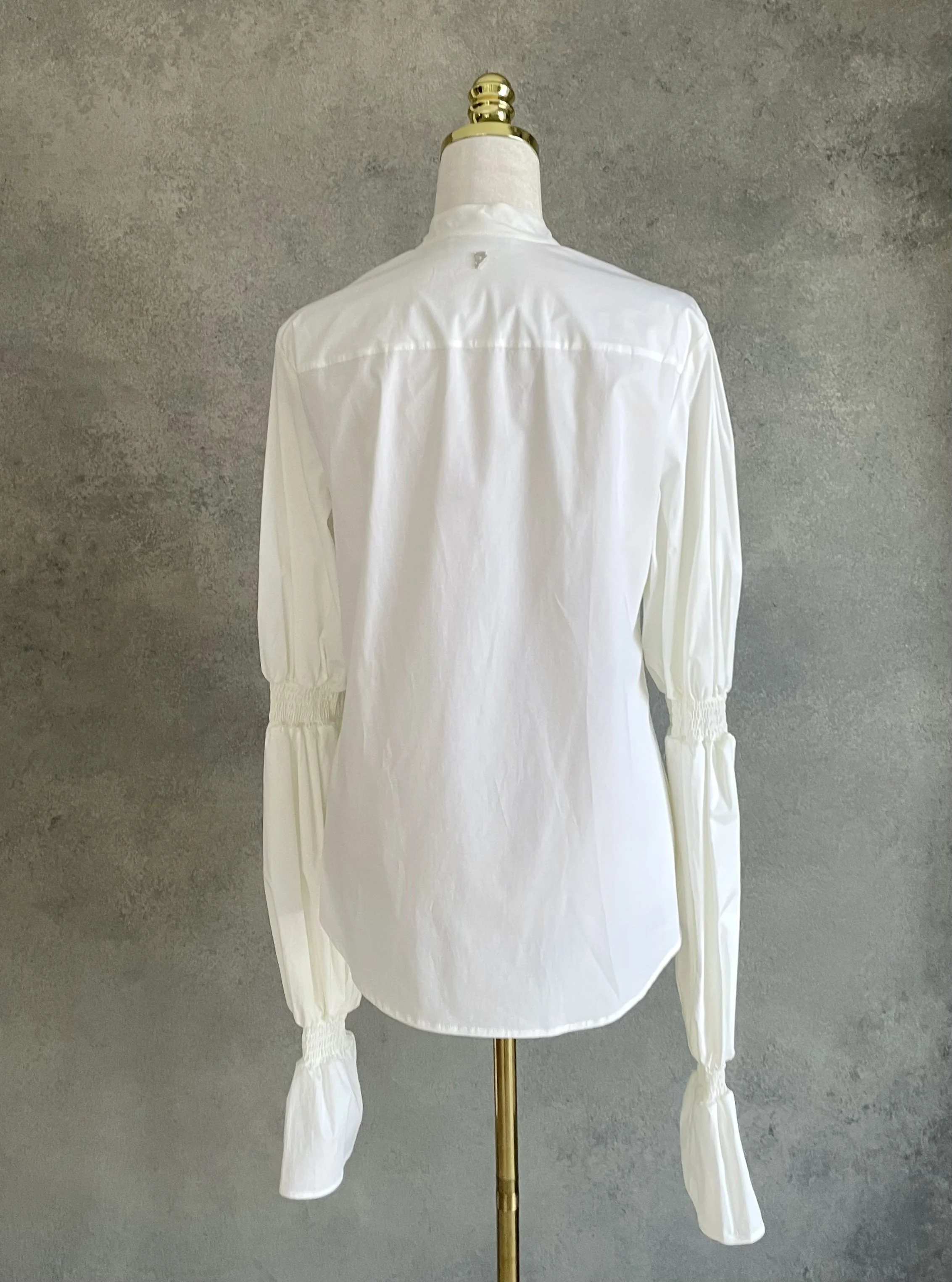Back view of the white Dondup shirt on a mannequin, showing the clean tailored back and high collar.