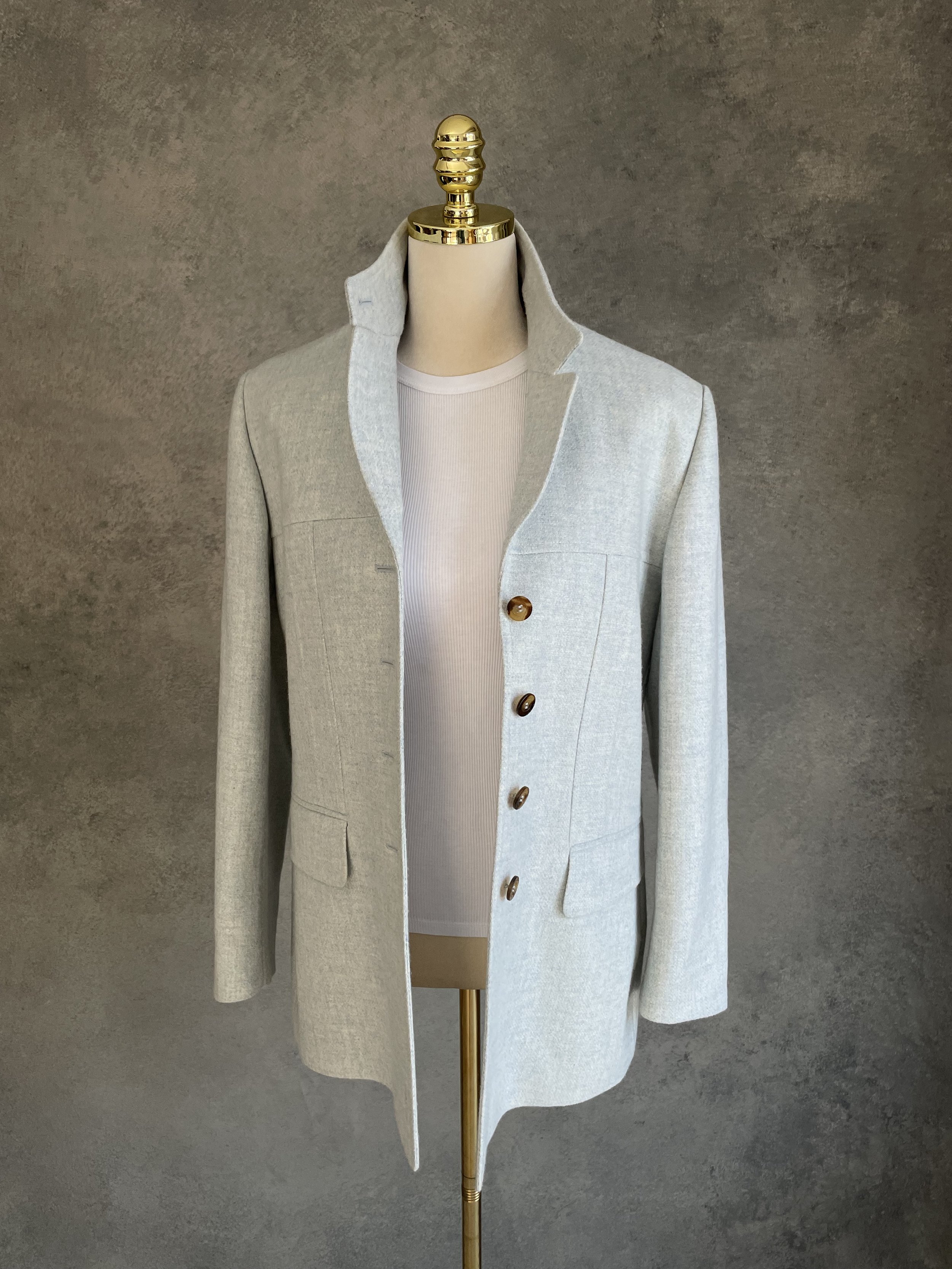 View of the Archie Pell blazer worn open on a mannequin, showing the internal lining and structure.