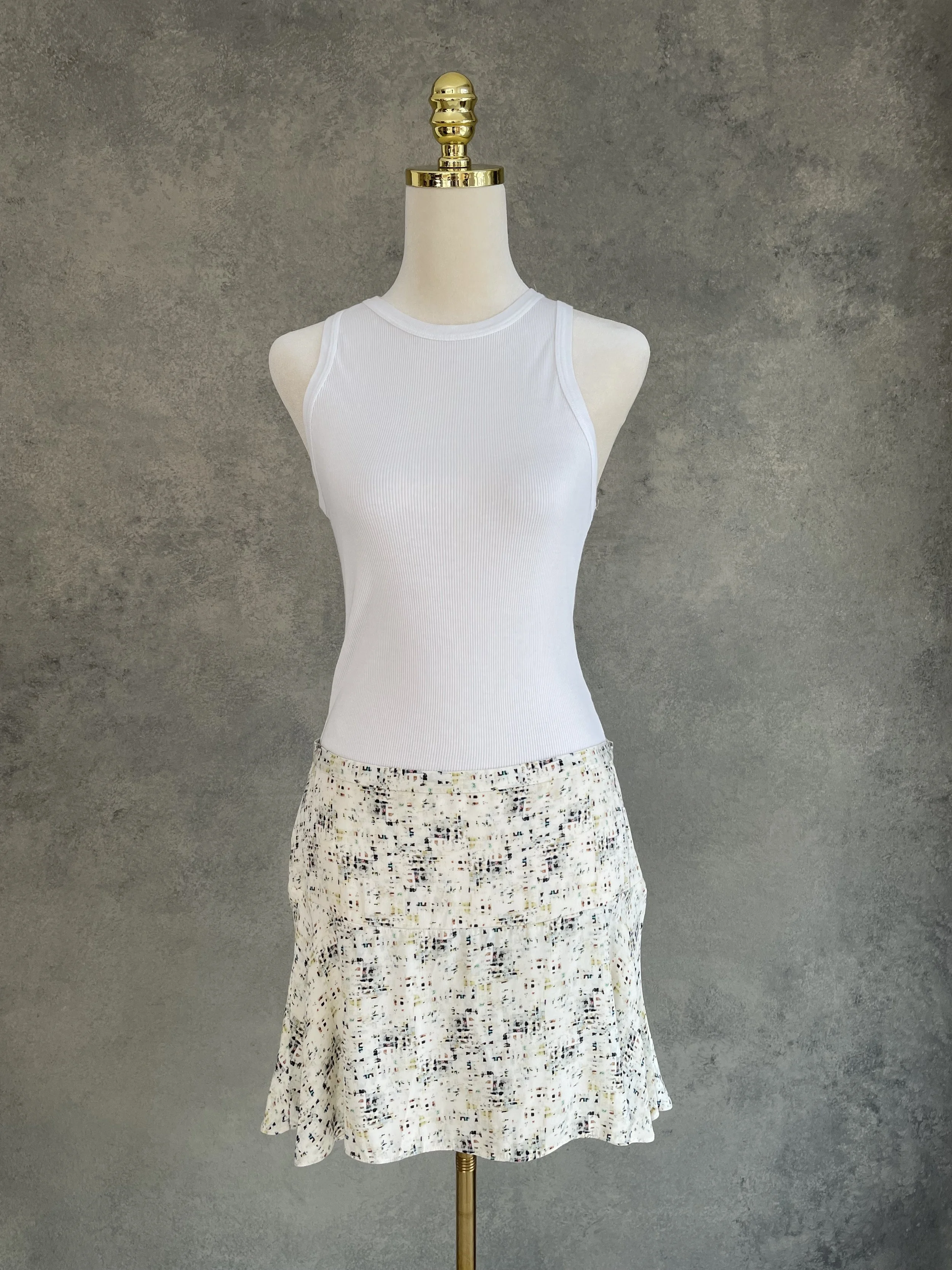 Front view of a Joseph abstract print mini skirt on a mannequin.