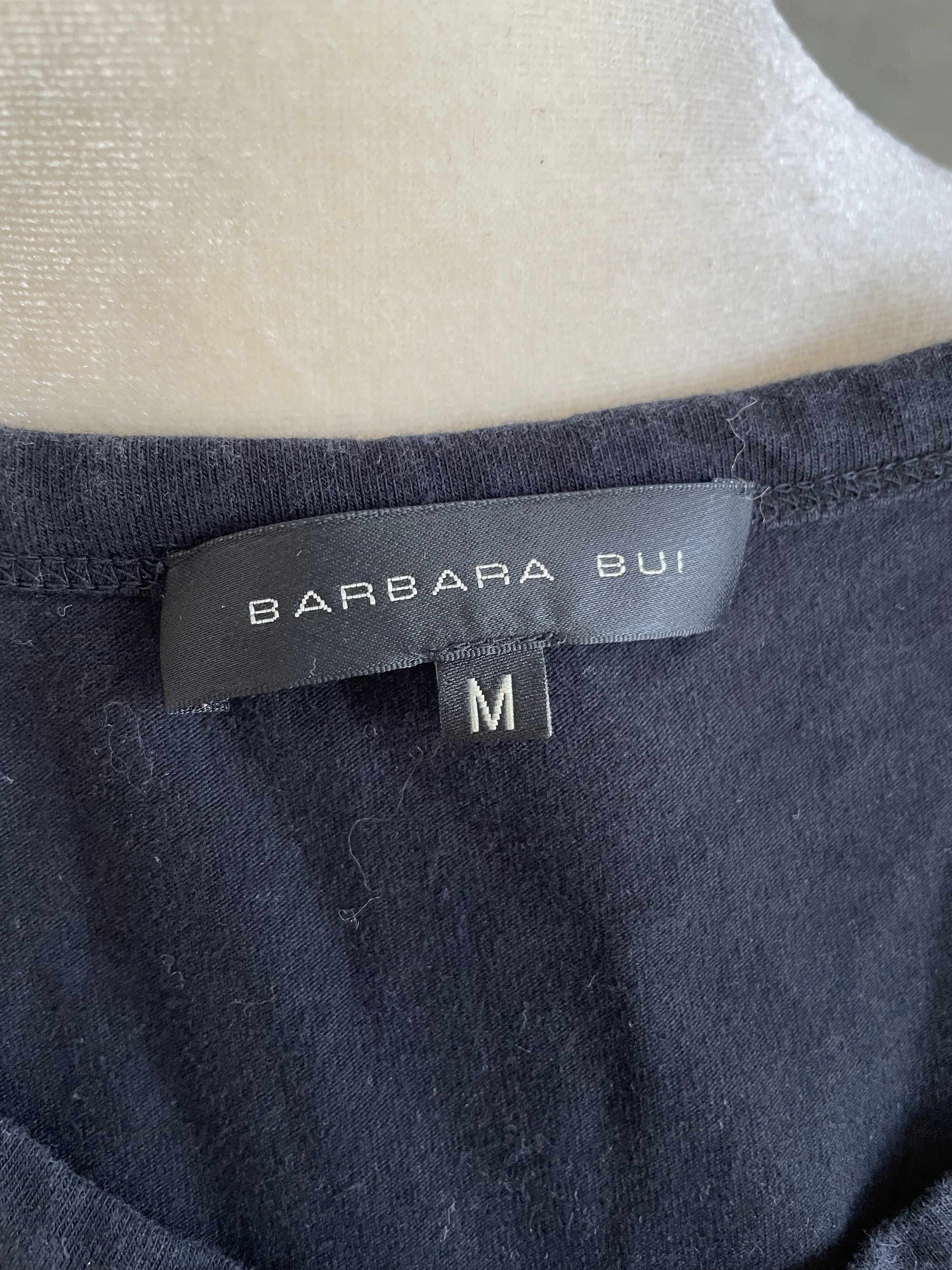 Internal garment label reading "BARBARA BUI" with "M" size tag below it.