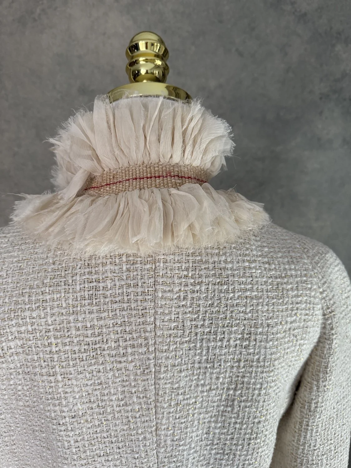 Detail of the structured high stand-up ruffle collar from the back