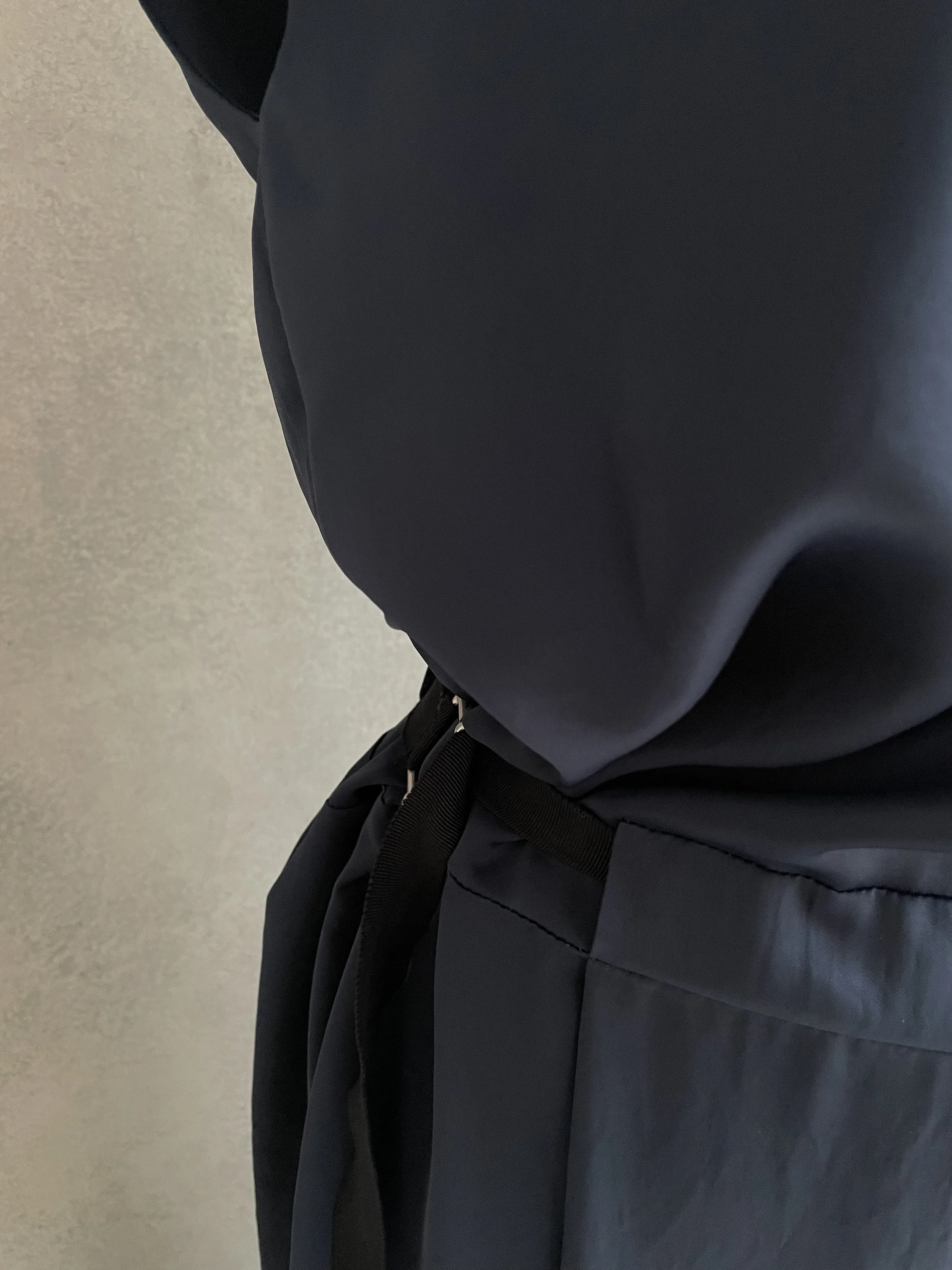 Detail view of the waist tie and side structure of the Rue Blanche dress.