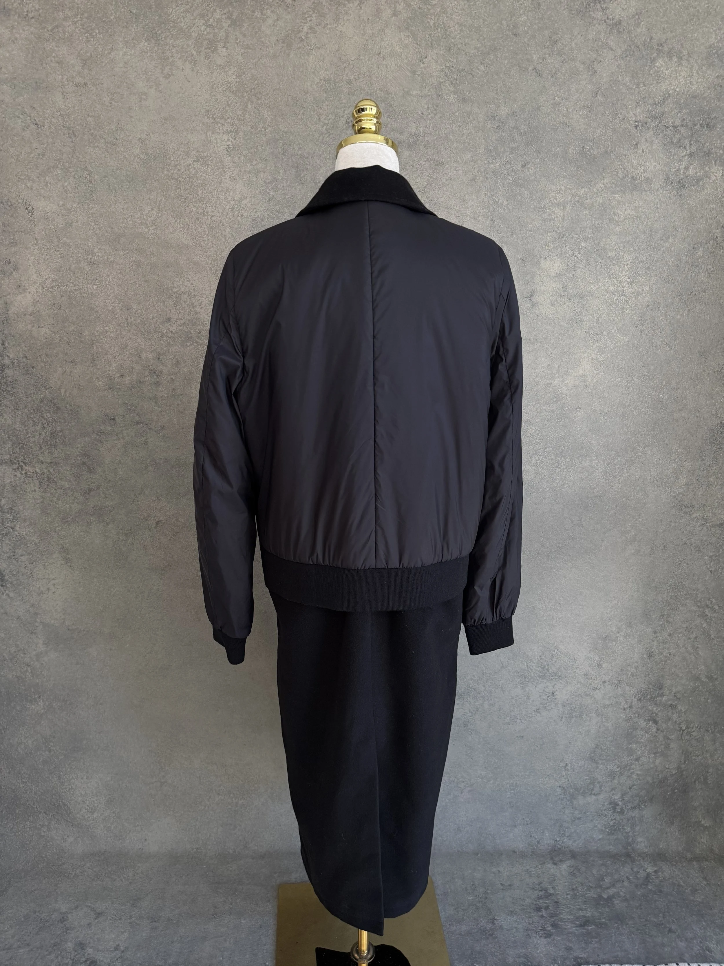 Back view of the coat featuring a smooth nylon upper back and a sporty bomber-style shoulder construction.