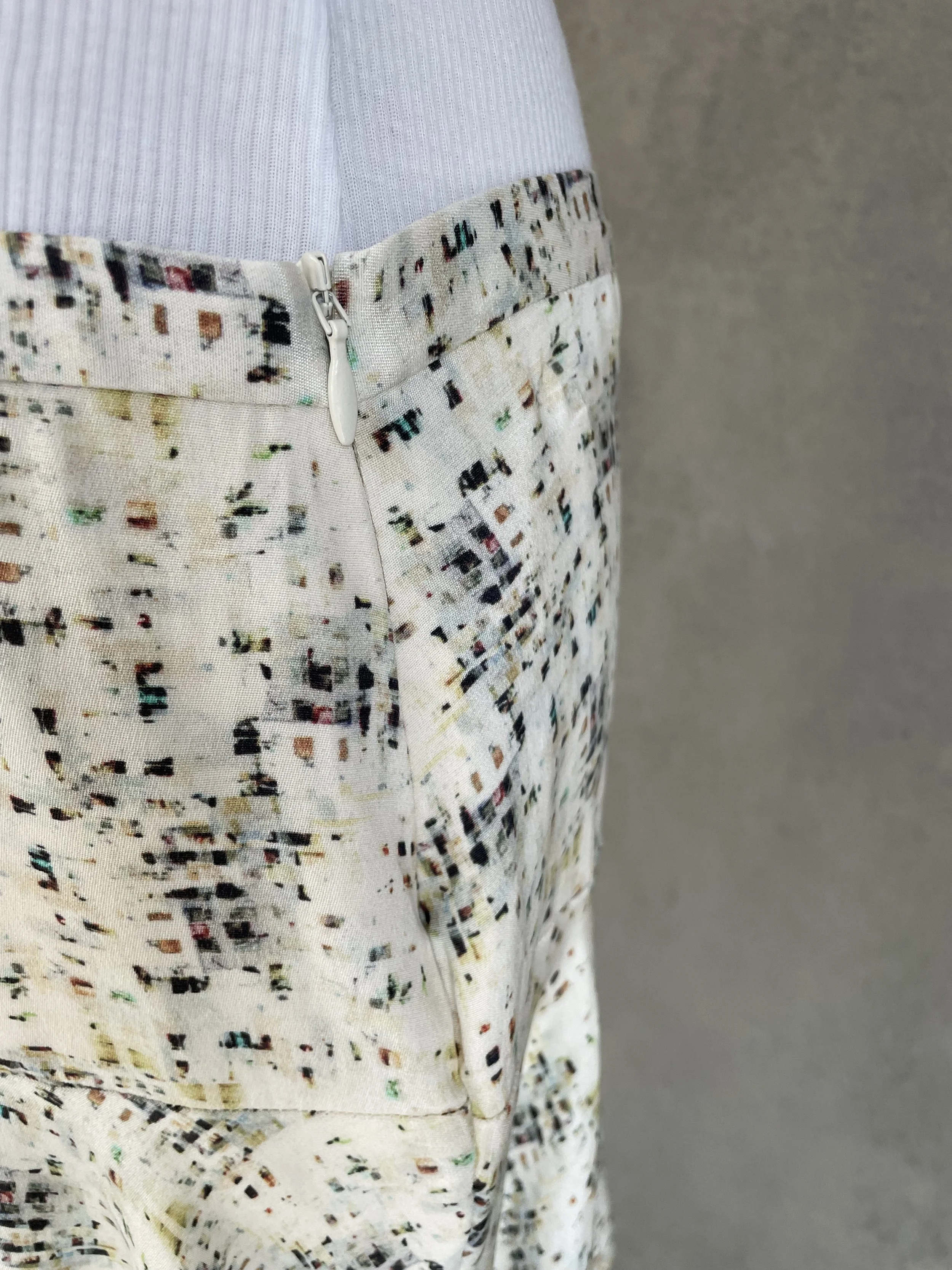 View of the side zipper detail on a Joseph mini skirt.
