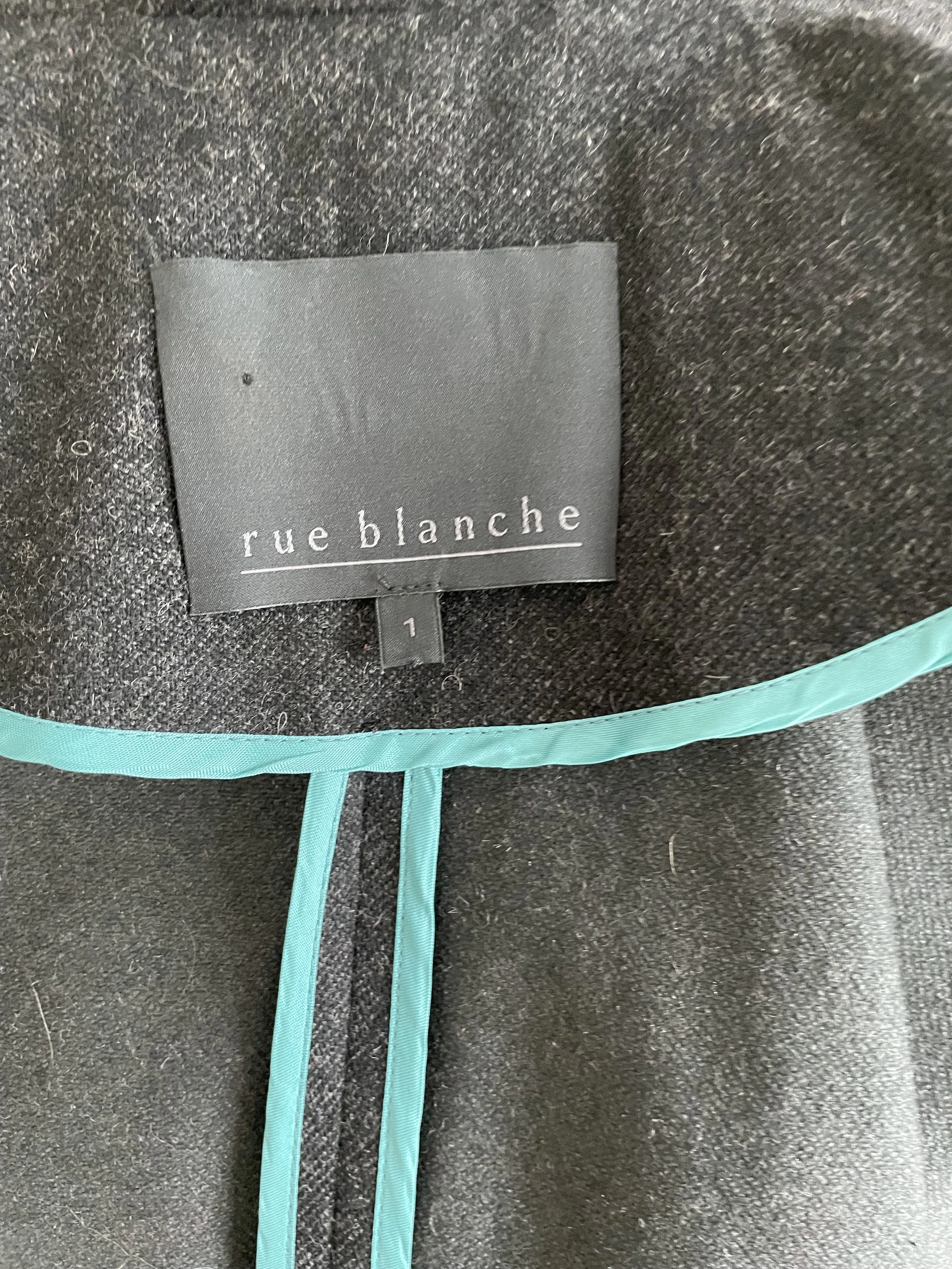 Close-up of the interior Rue Blanche brand label and teal piping detail.