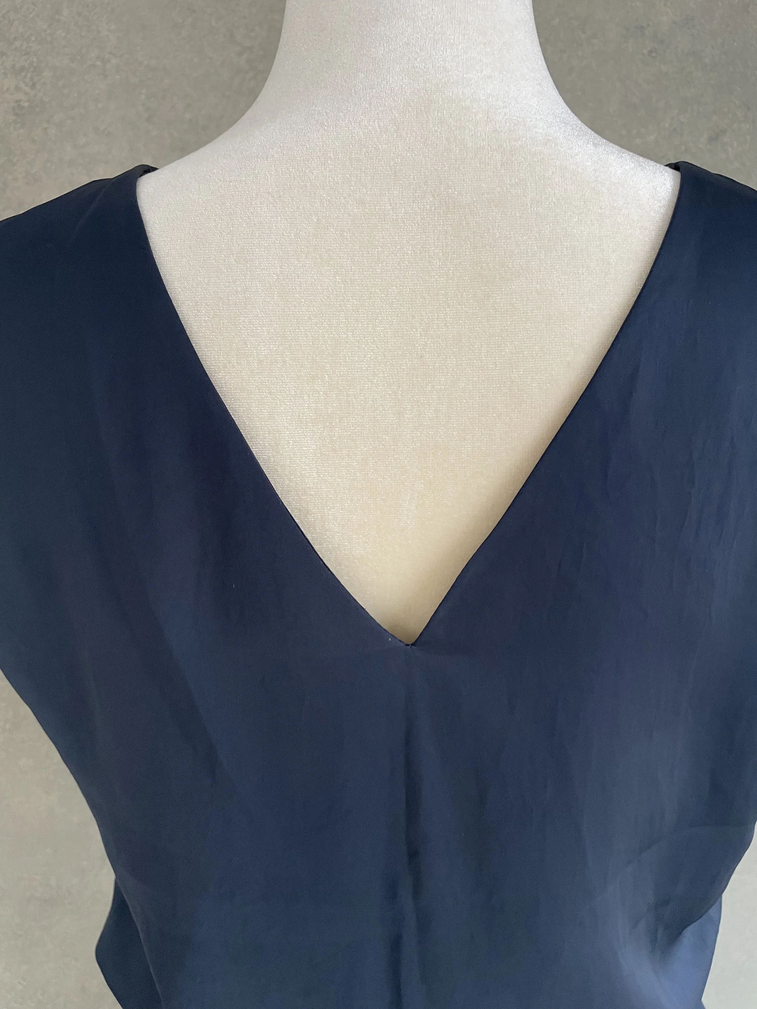 Close-up of the V-neckline detail on the back of the dress.