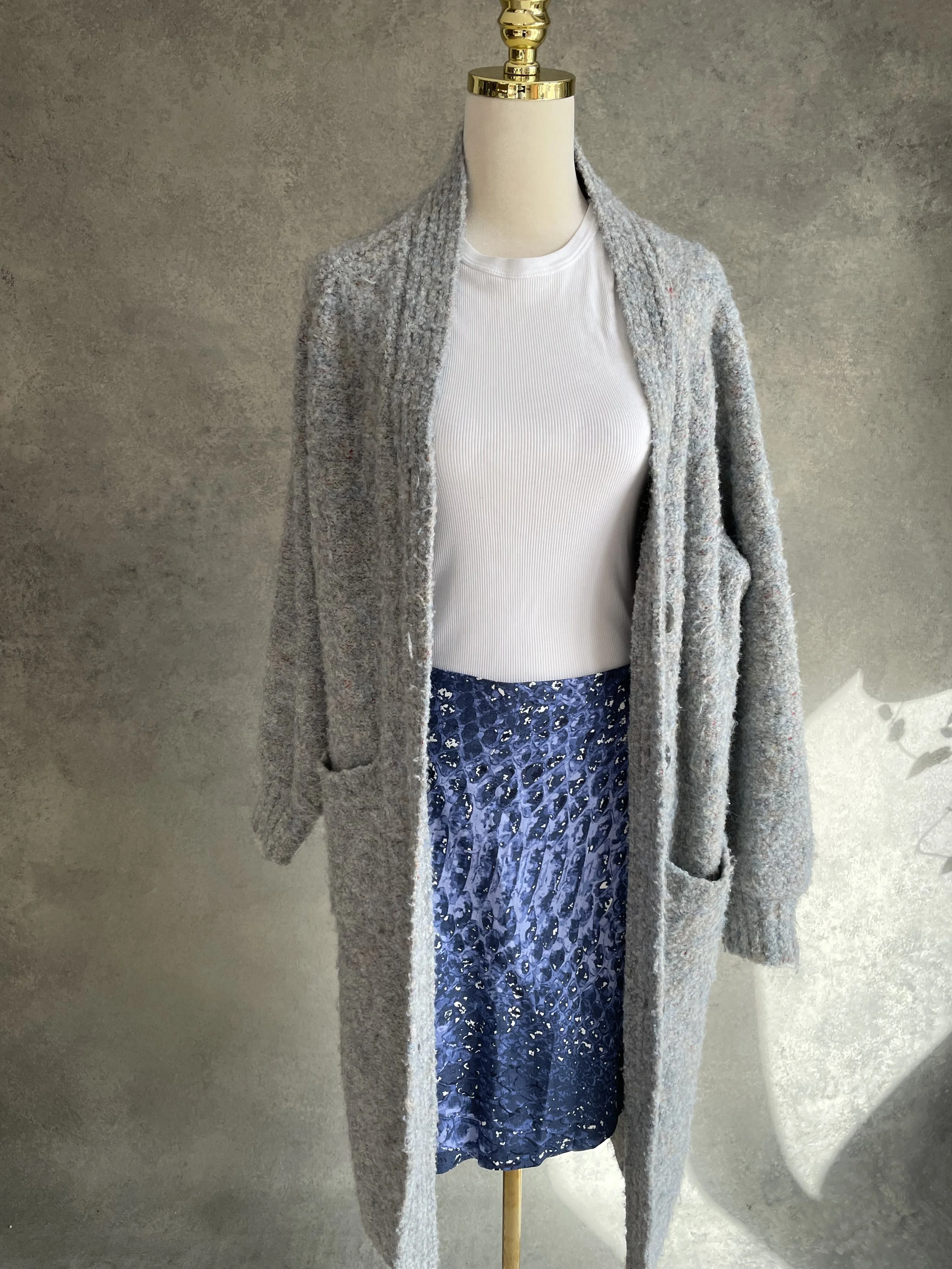 Gigue skirt styled with a grey knit cardigan, demonstrating layering versatility.