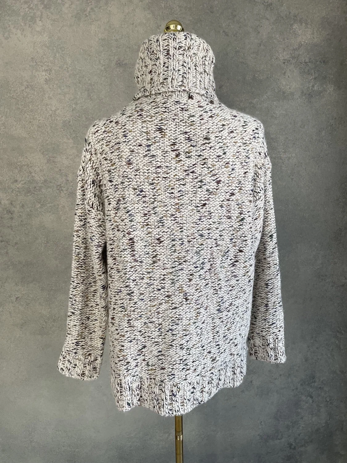 Back view of the Essentiel Antwerp speckled knit sweater showing the uniform chunky texture and ribbed hemline.