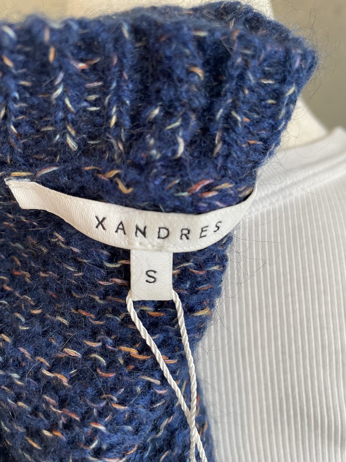 Close-up of the interior Xandres brand label and size S tag.