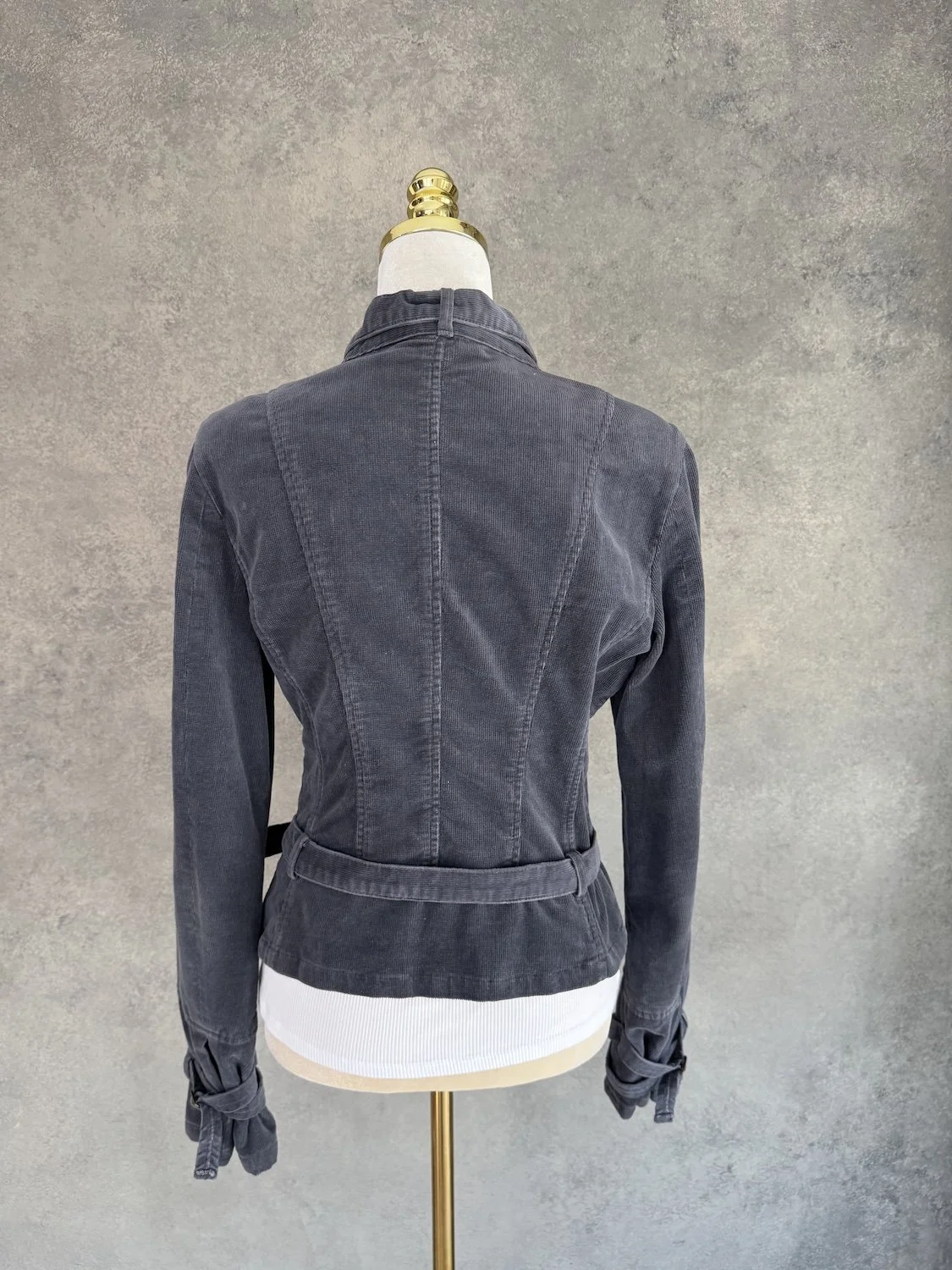 Rear view of the dark grey corduroy biker jacket, highlighting the panel seams and tailored back.