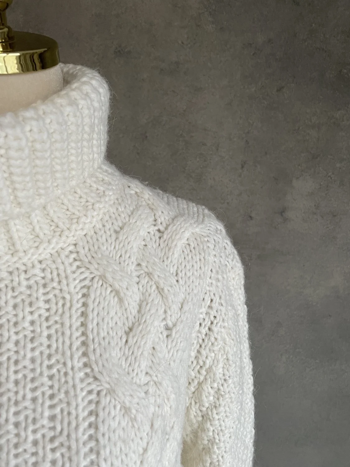 Shoulder transition showing the cable knit detail.