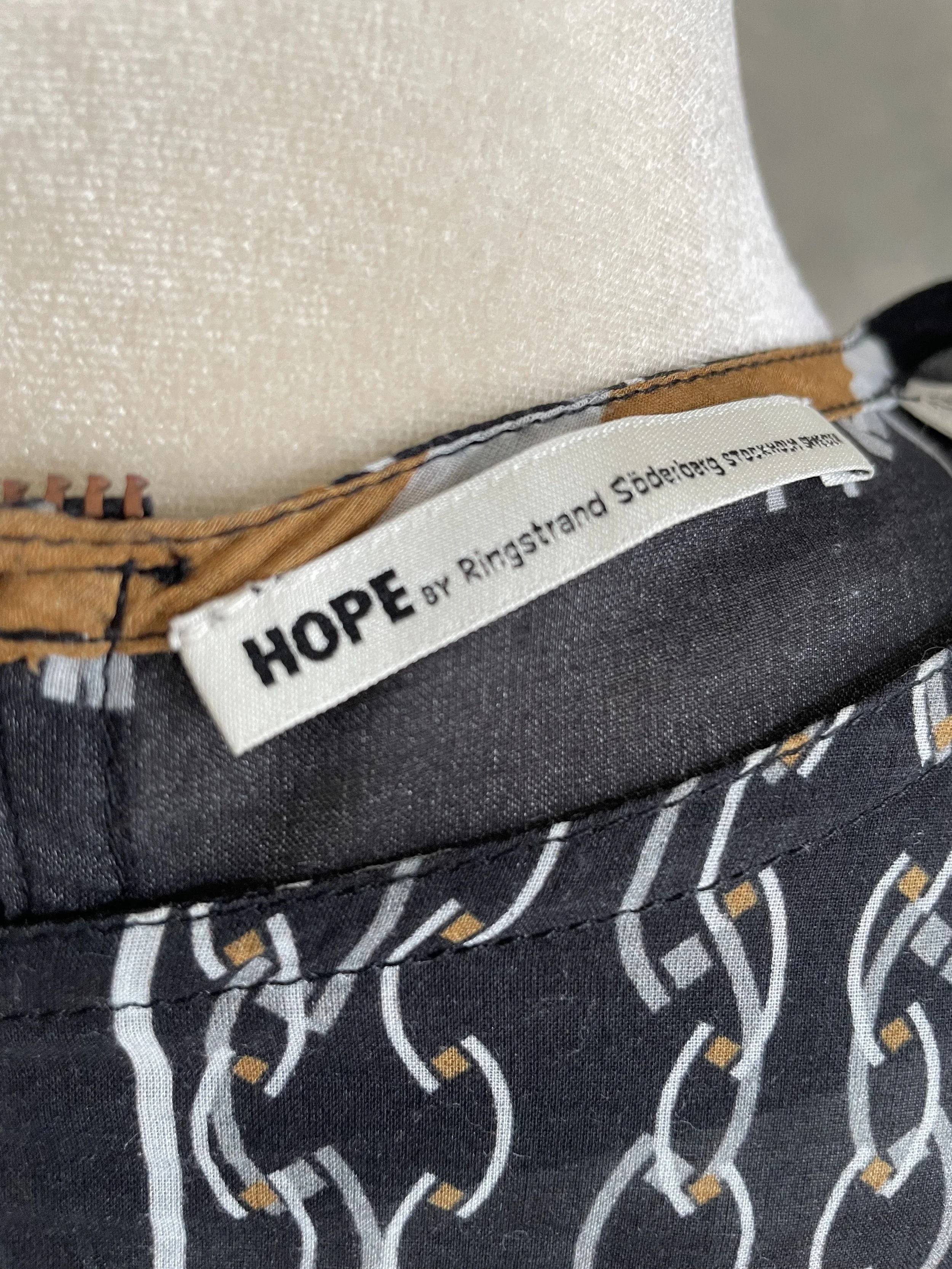 Close-up of the inner neck label reading "HOPE by Ringstrand Söderberg Stockholm Sweden".