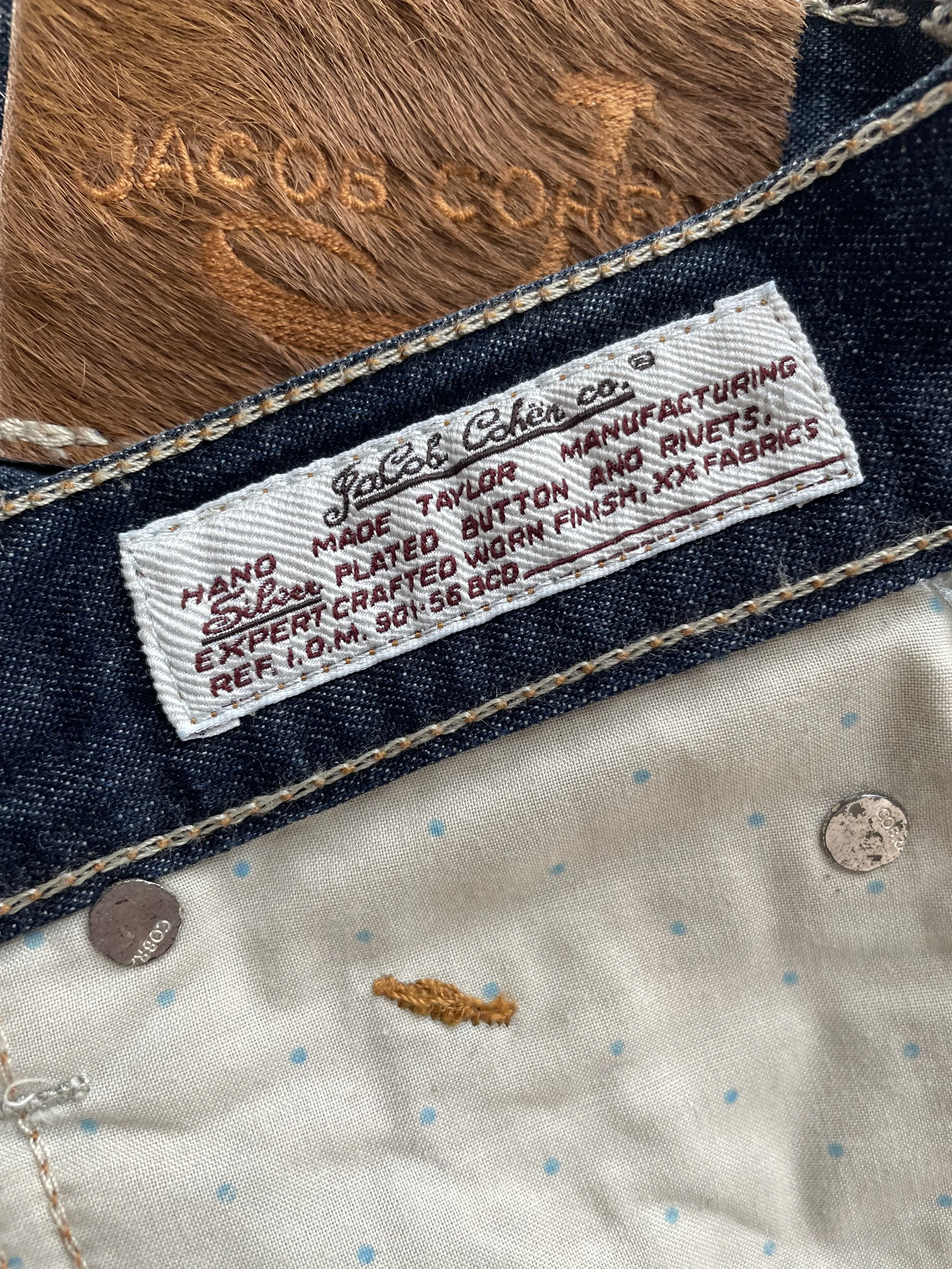 Detailed shot of the inner waist label and Japanese denim construction details of the Jacob Cohën jeans.