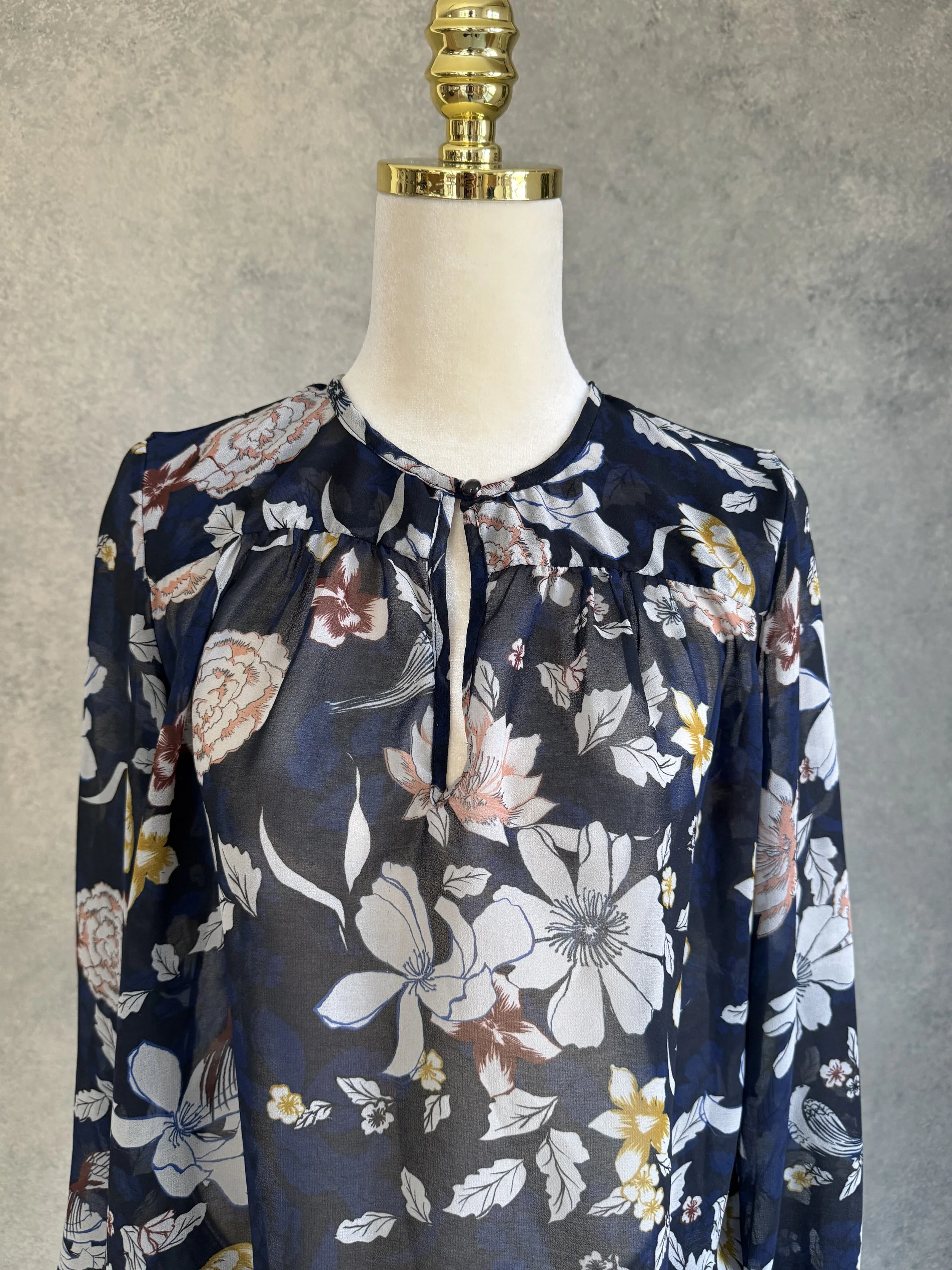 Full front view of the Gigue floral navy blouse, showing the clean collar structure and versatile long-sleeve fit