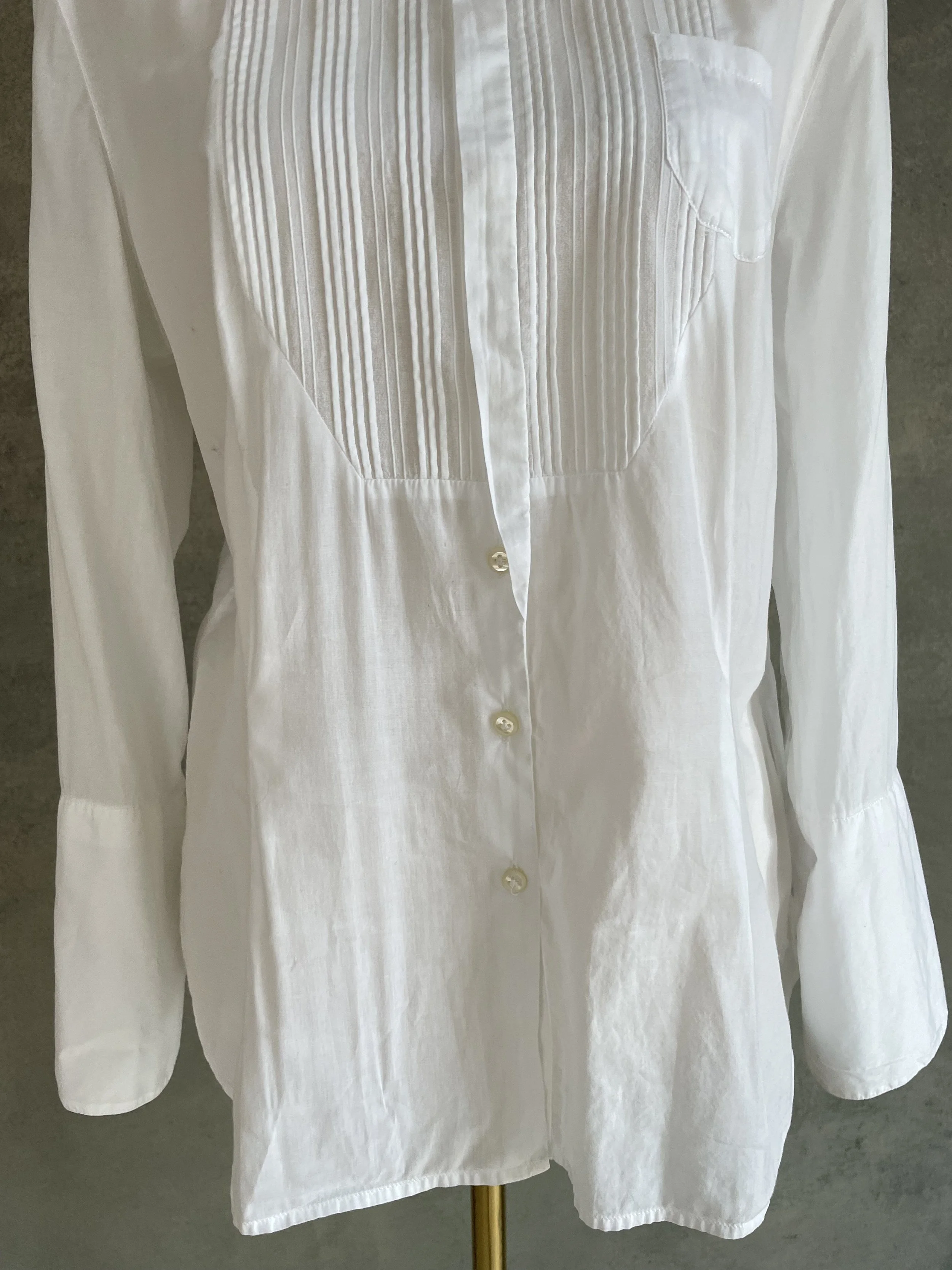 Front view of the white shirt showing the button-down placket."