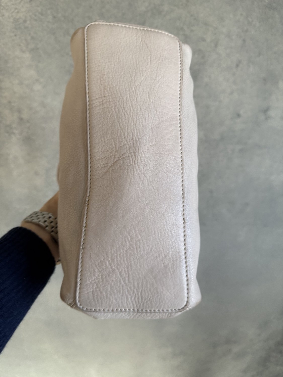 Bottom view of Adax beige leather handbag showing clean base and delicate stitching