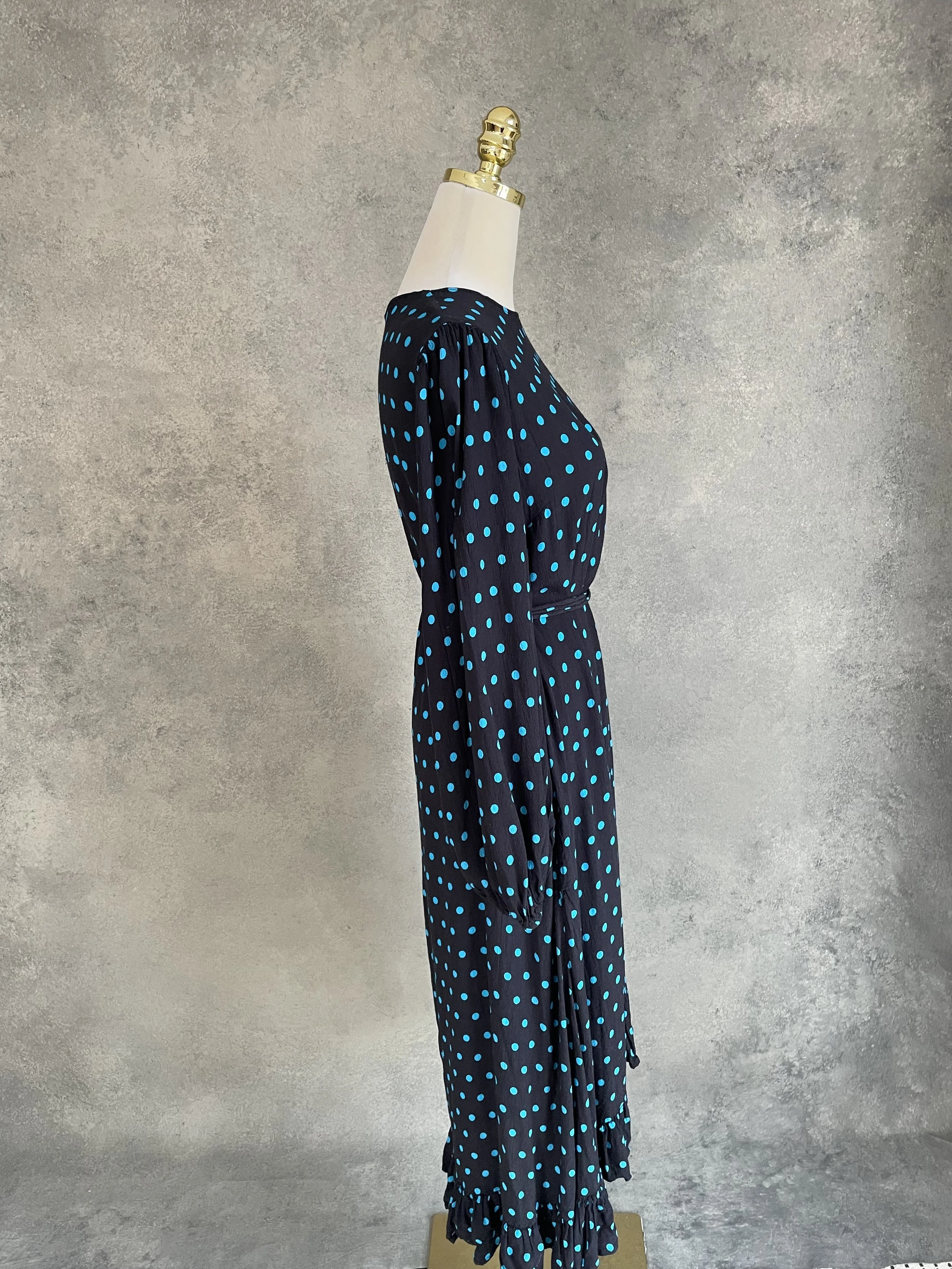 Side view of the Essentiel Antwerp dress, showing the longer back hem and silhouette.