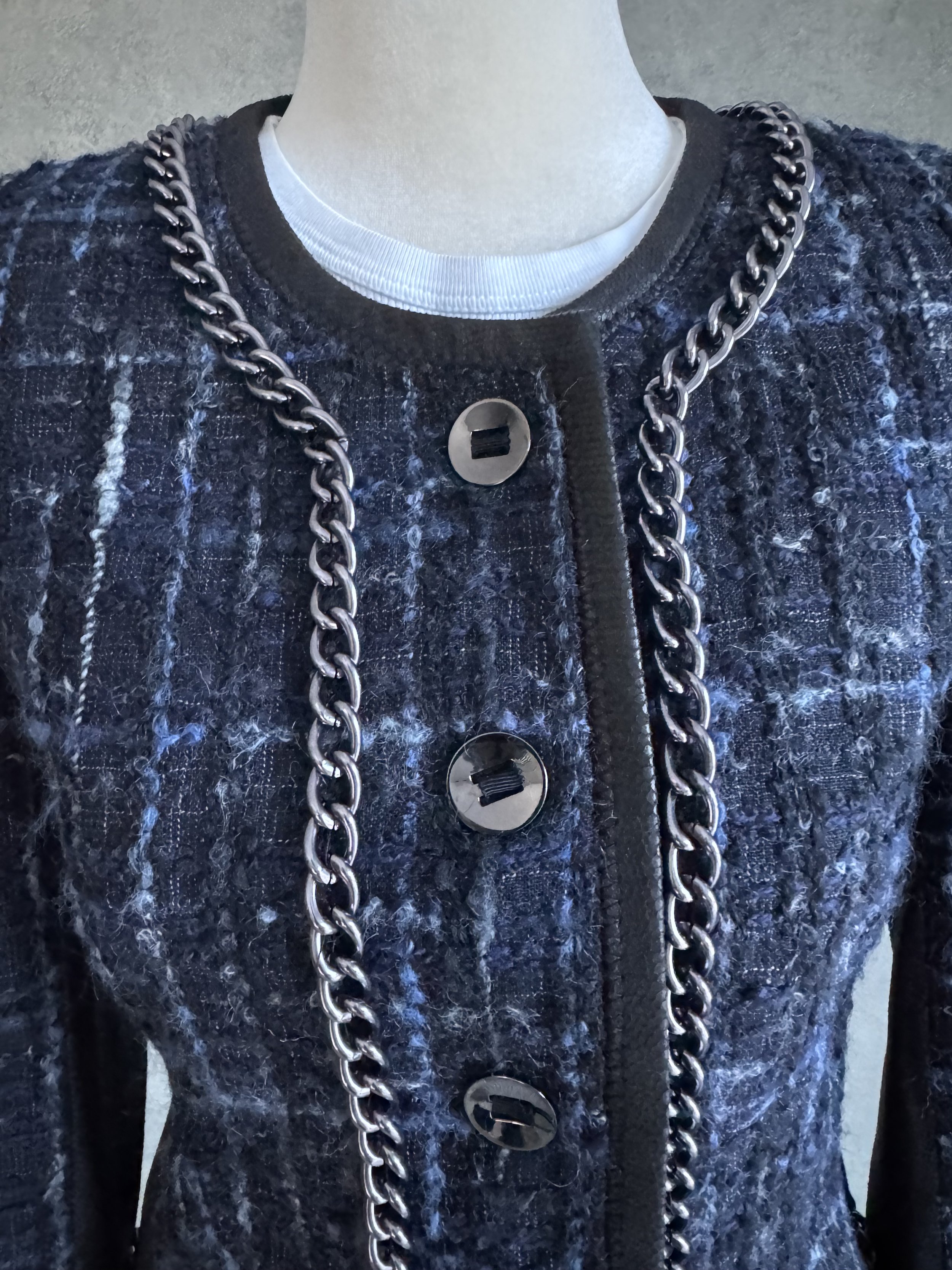 Close-up front view of the Riani blazer, highlighting the chain-link detail along the neckline and front button placket