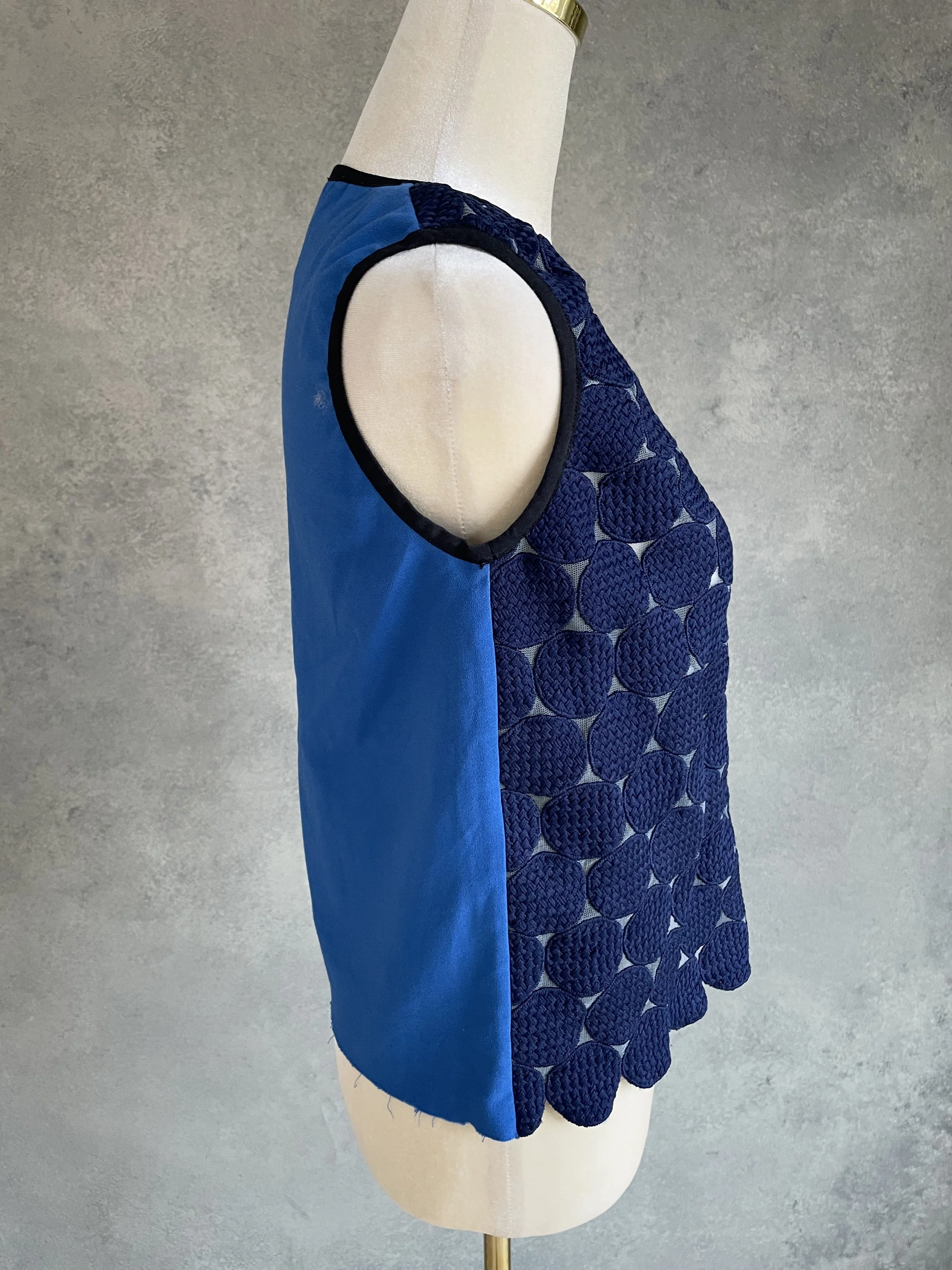 VSide view of the blue Vladimir Karaleev top, showing the contrast between the textured front and solid blue back fabric.
