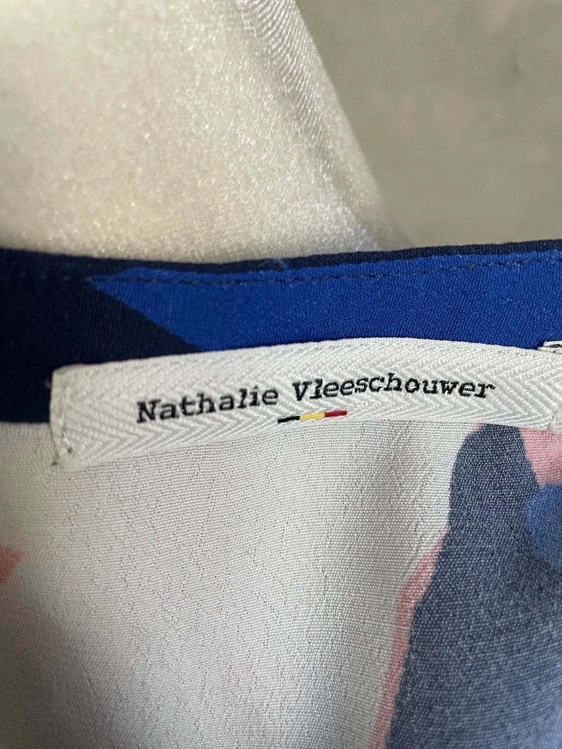 Nathalie Vleeschouwer interior brand neck label with Belgian flag detail