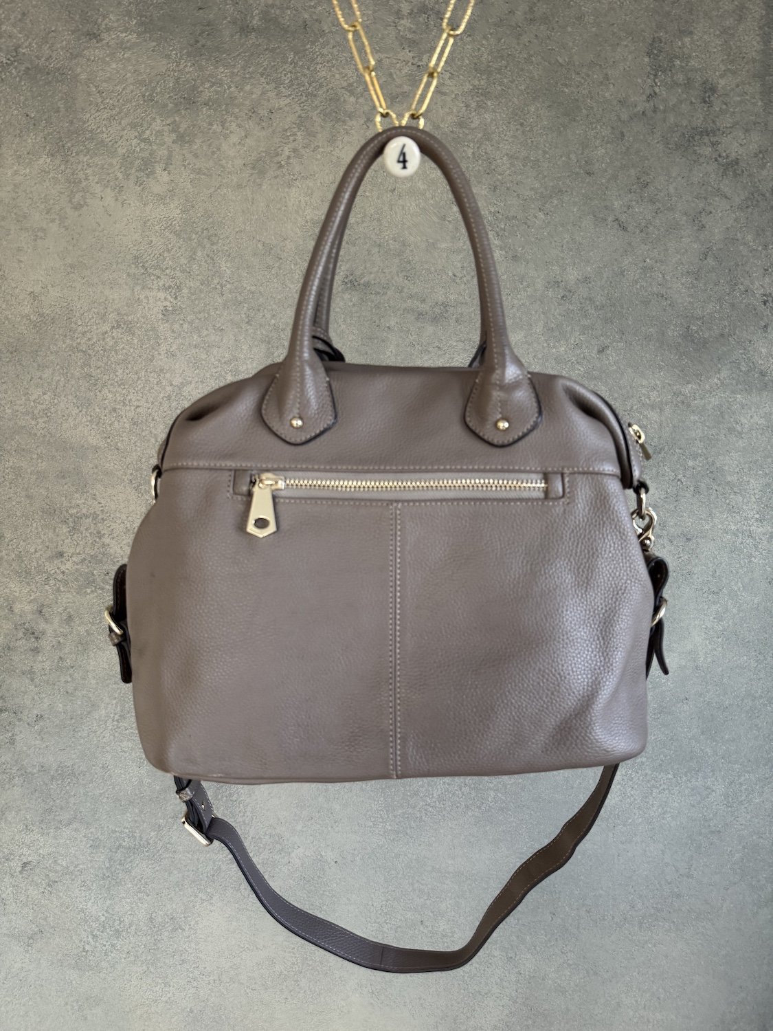 Back view of Smaak Amsterdam leather satchel featuring secure exterior zip pocket"