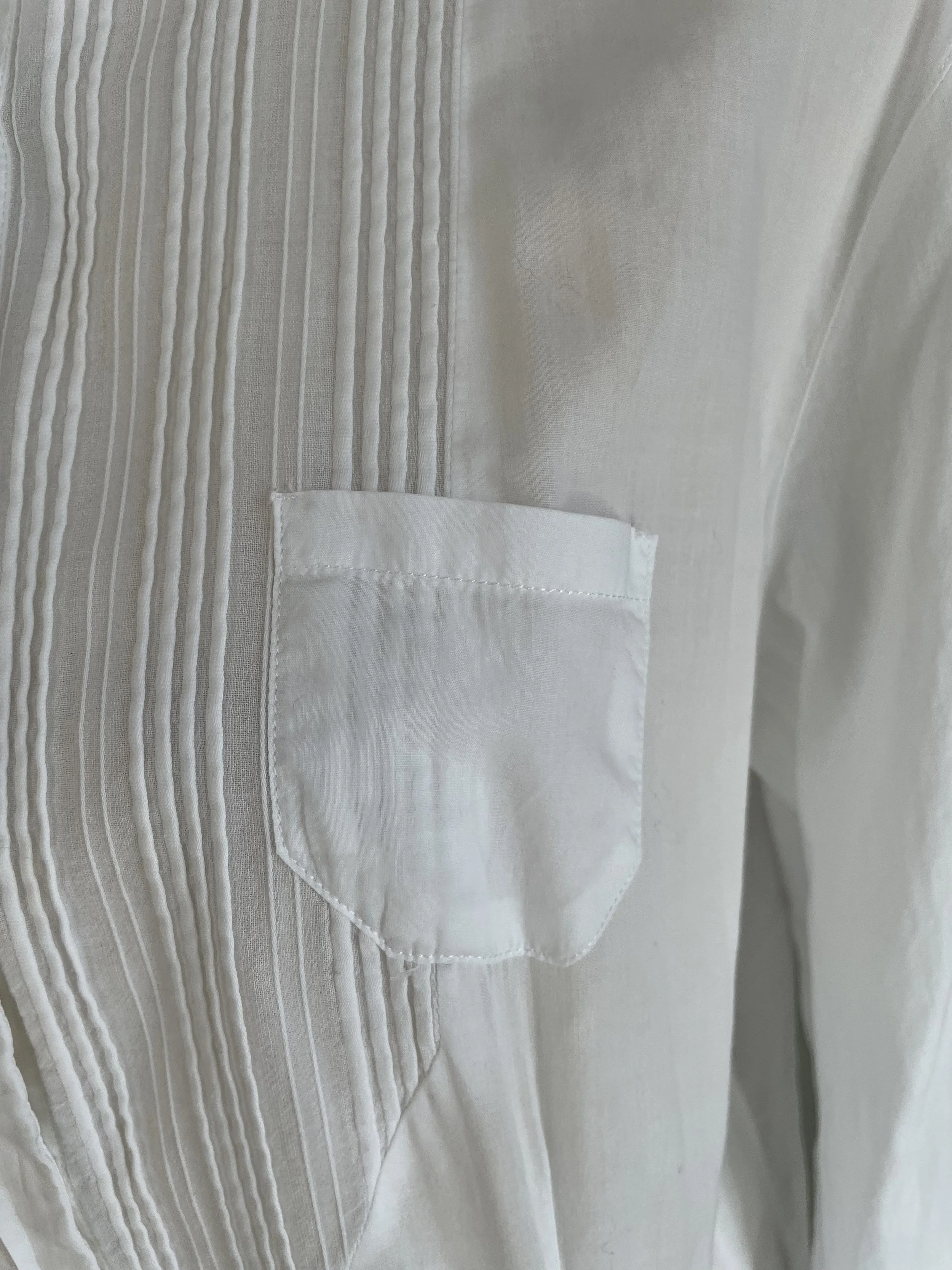 Close-up of the small breast pocket on the pleated bib section.